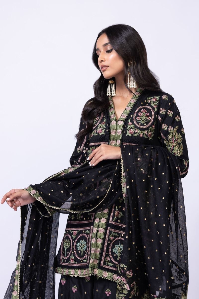 Model wearing Khaadi EST24608A black dress with intricate multicolor embroidery and gharara. Shop Pakistani clothes online in the UK now.