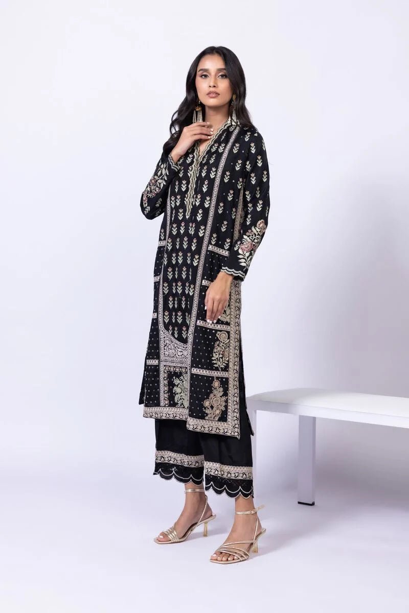 Model wearing Khaadi EST24610B black dress with intricate red and gold prints. Shop Pakistani clothes online in the UK now.