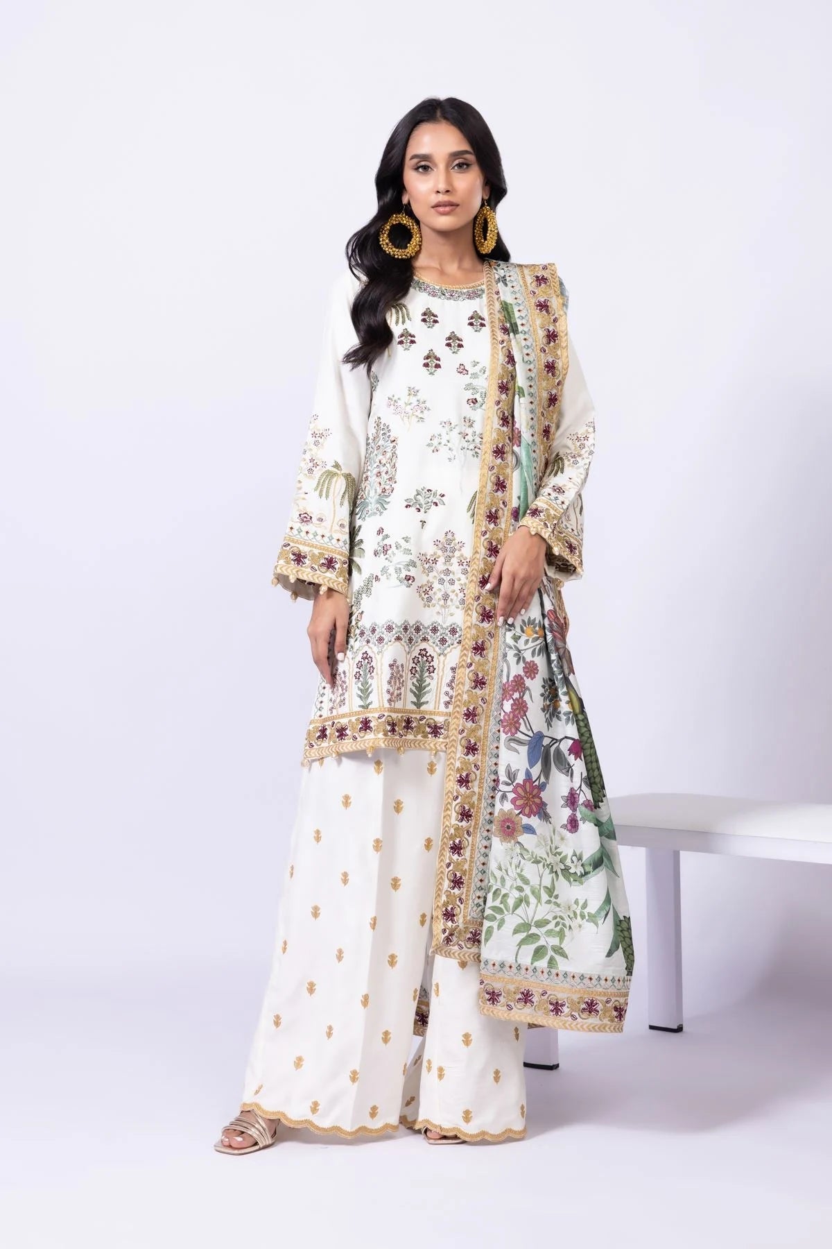 Model wearing Khaadi EST24613B off - white dress with intricate multicolor embroidery. Shop Pakistani clothes online in the UK now.