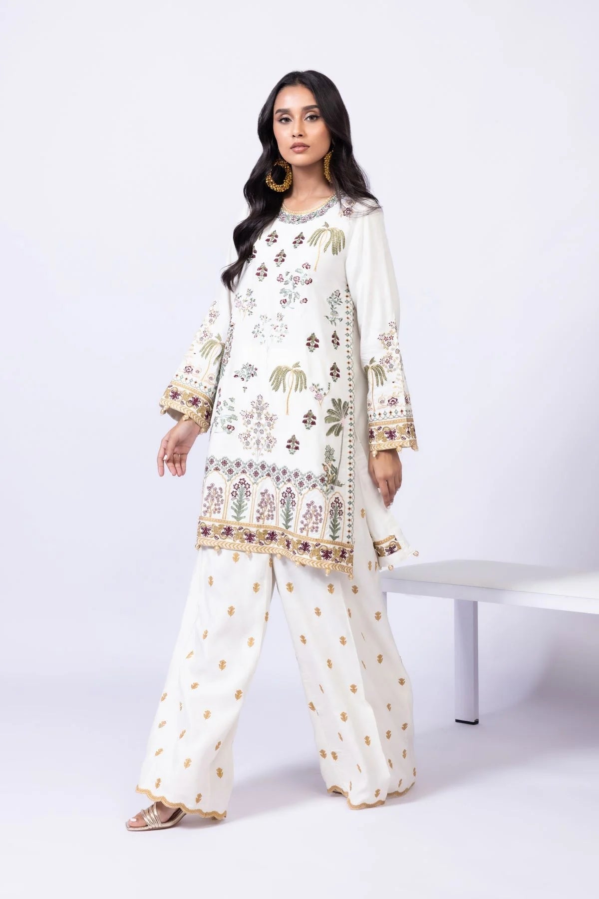 Model wearing Khaadi EST24613B off - white dress with intricate multicolor embroidery. Shop Pakistani clothes online in the UK now.