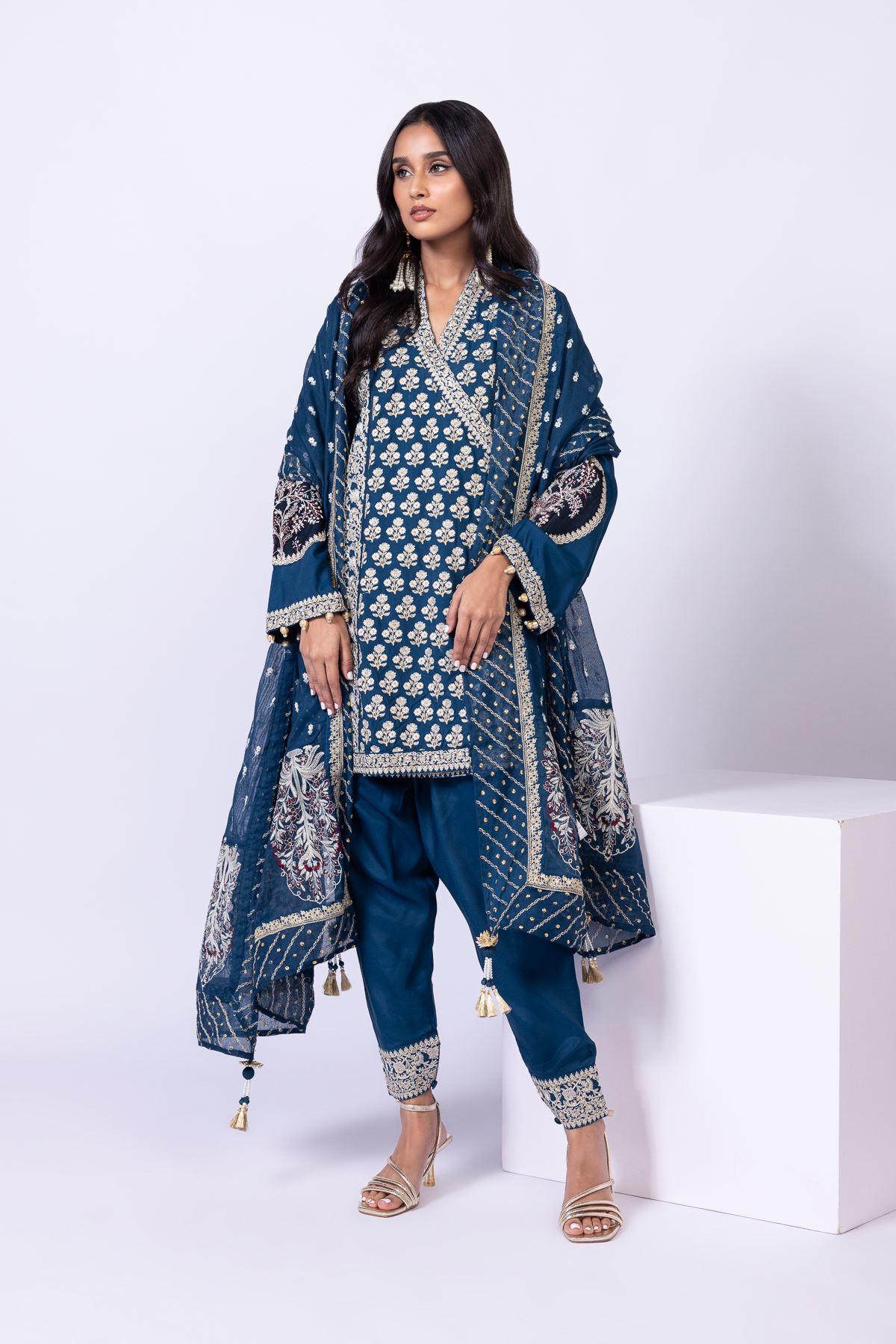 Model wearing Khaadi EST24615A teal dress with intricate embroidery and tassel details. Shop Pakistani clothes online in the UK now.