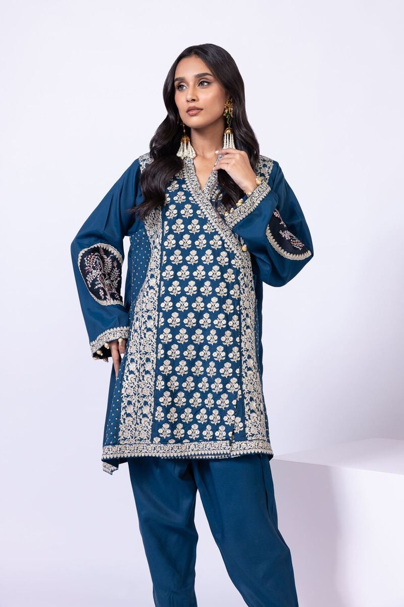 Model wearing Khaadi EST24615A teal dress with intricate embroidery and tassel details. Shop Pakistani clothes online in the UK now.