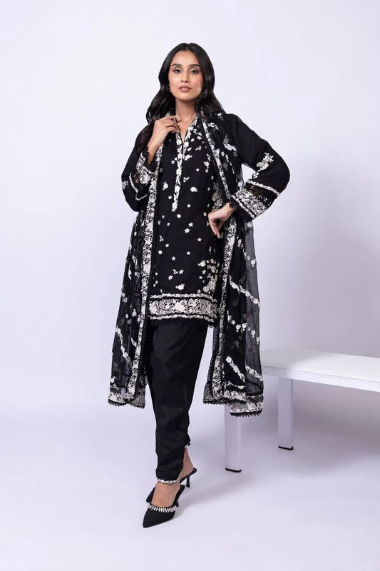 Model wearing Khaadi EST24633B black dress with elegant white embroidery and lace details. Shop Pakistani clothes online in the UK now.