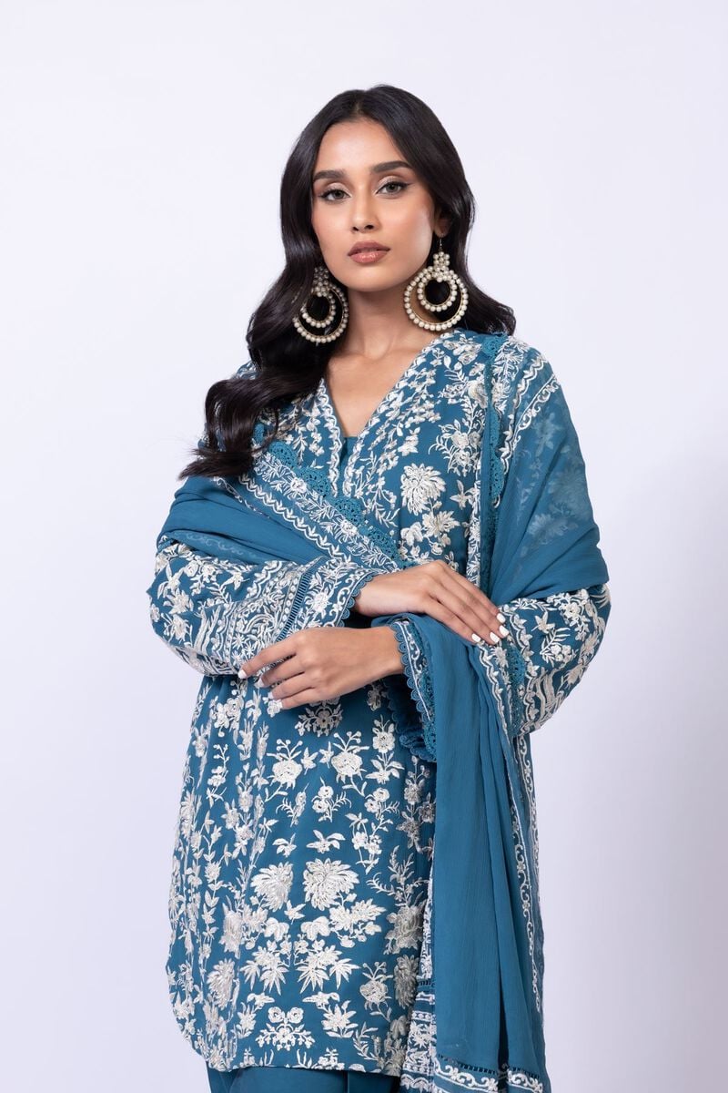 Model wearing Khaadi EST24634B teal blue embroidered dress with matching dupatta and trousers. Shop Pakistani clothes online in the UK now.