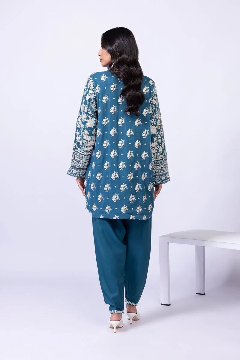 Model wearing Khaadi EST24634B teal blue embroidered dress with matching dupatta and trousers. Shop Pakistani clothes online in the UK now.