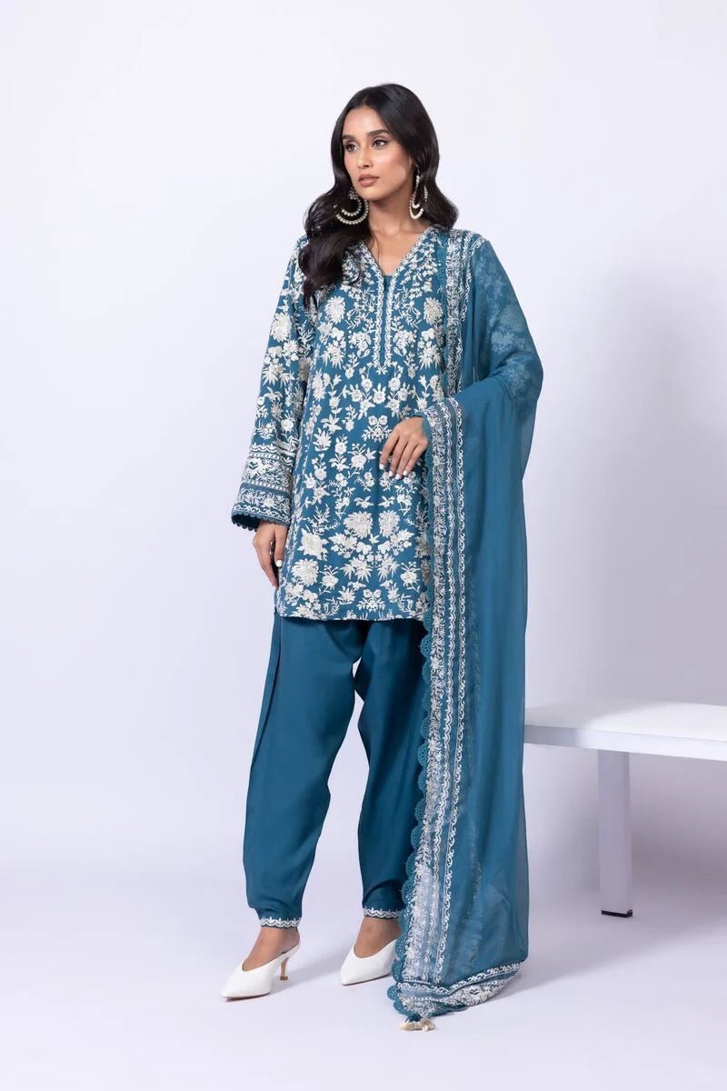 Model wearing Khaadi EST24634B teal blue embroidered dress with matching dupatta and trousers. Shop Pakistani clothes online in the UK now.