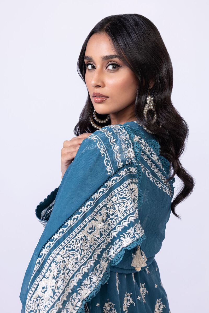 Model wearing Khaadi EST24634B teal blue embroidered dress with matching dupatta and trousers. Shop Pakistani clothes online in the UK now.