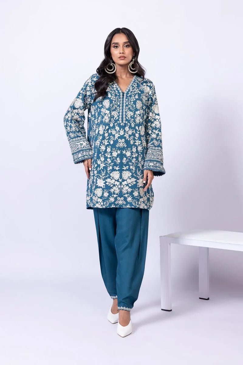 Model wearing Khaadi EST24634B teal blue embroidered dress with matching dupatta and trousers. Shop Pakistani clothes online in the UK now.