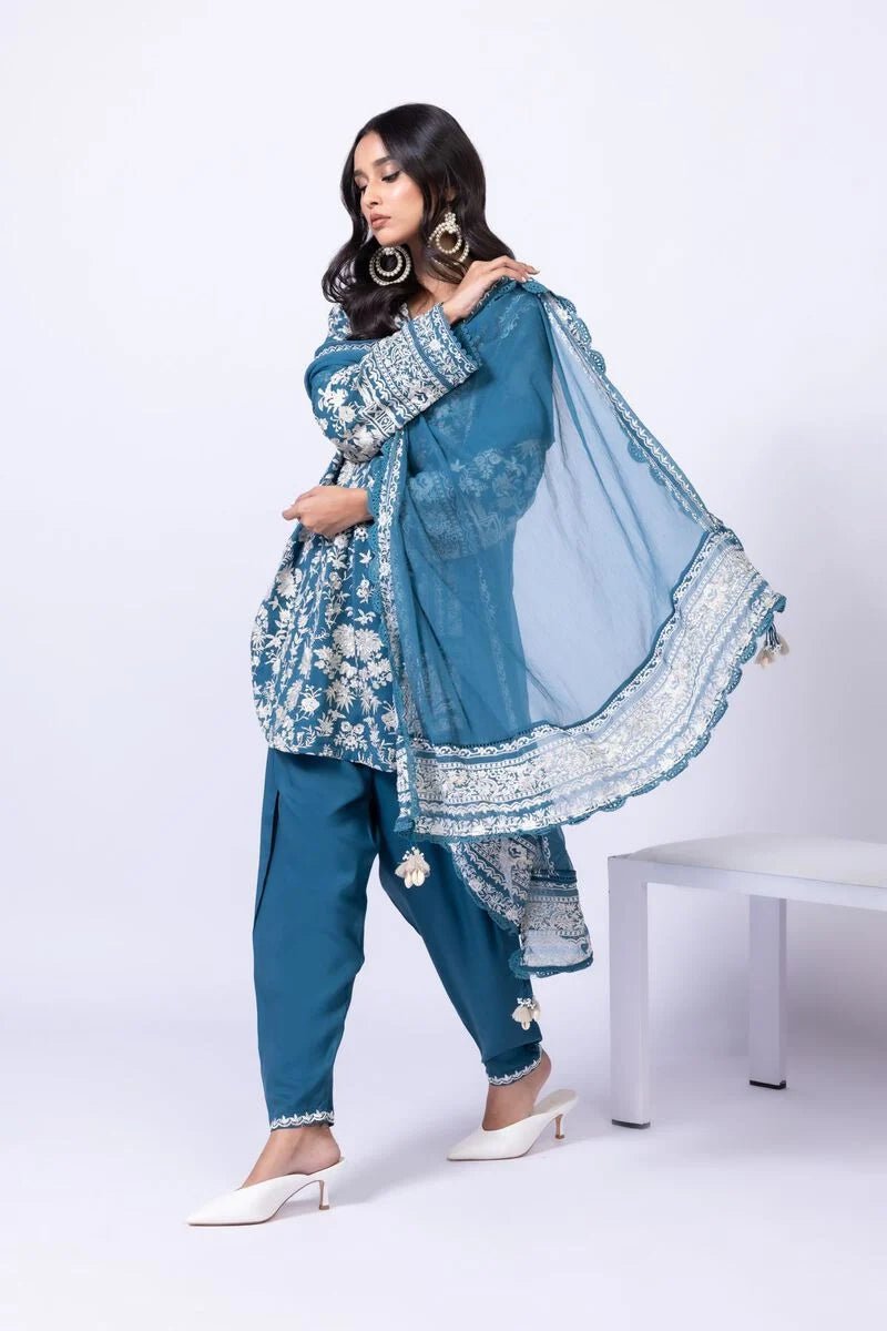 Model wearing Khaadi EST24634B teal blue embroidered dress with matching dupatta and trousers. Shop Pakistani clothes online in the UK now.