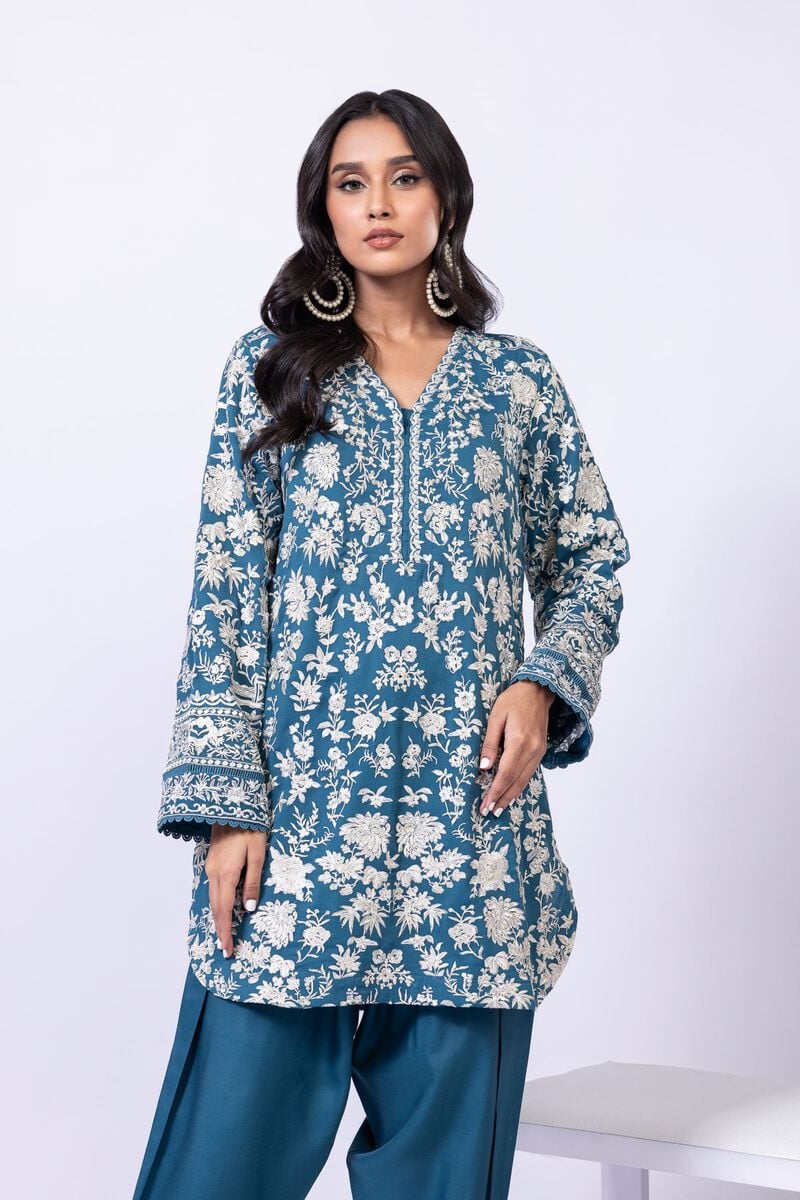 Model wearing Khaadi EST24634B teal blue embroidered dress with matching dupatta and trousers. Shop Pakistani clothes online in the UK now.