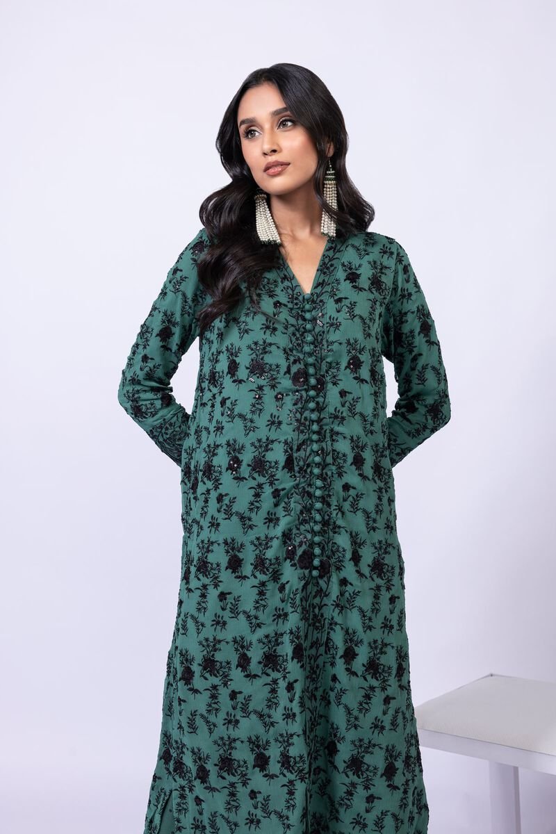 Model wearing Khaadi EST24635A green dress with black embroidered details and chiffon dupatta. Shop Pakistani clothes online in the UK now.