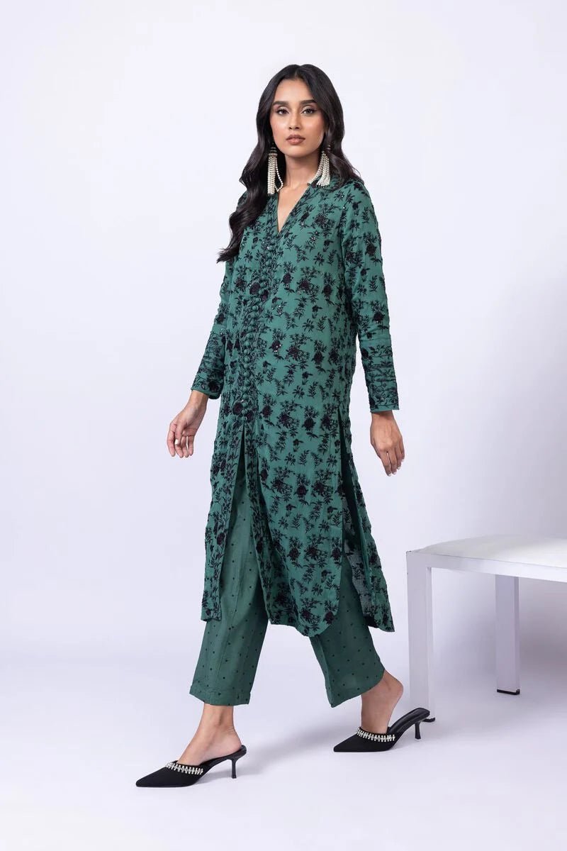 Model wearing Khaadi EST24635A green dress with black embroidered details and chiffon dupatta. Shop Pakistani clothes online in the UK now.