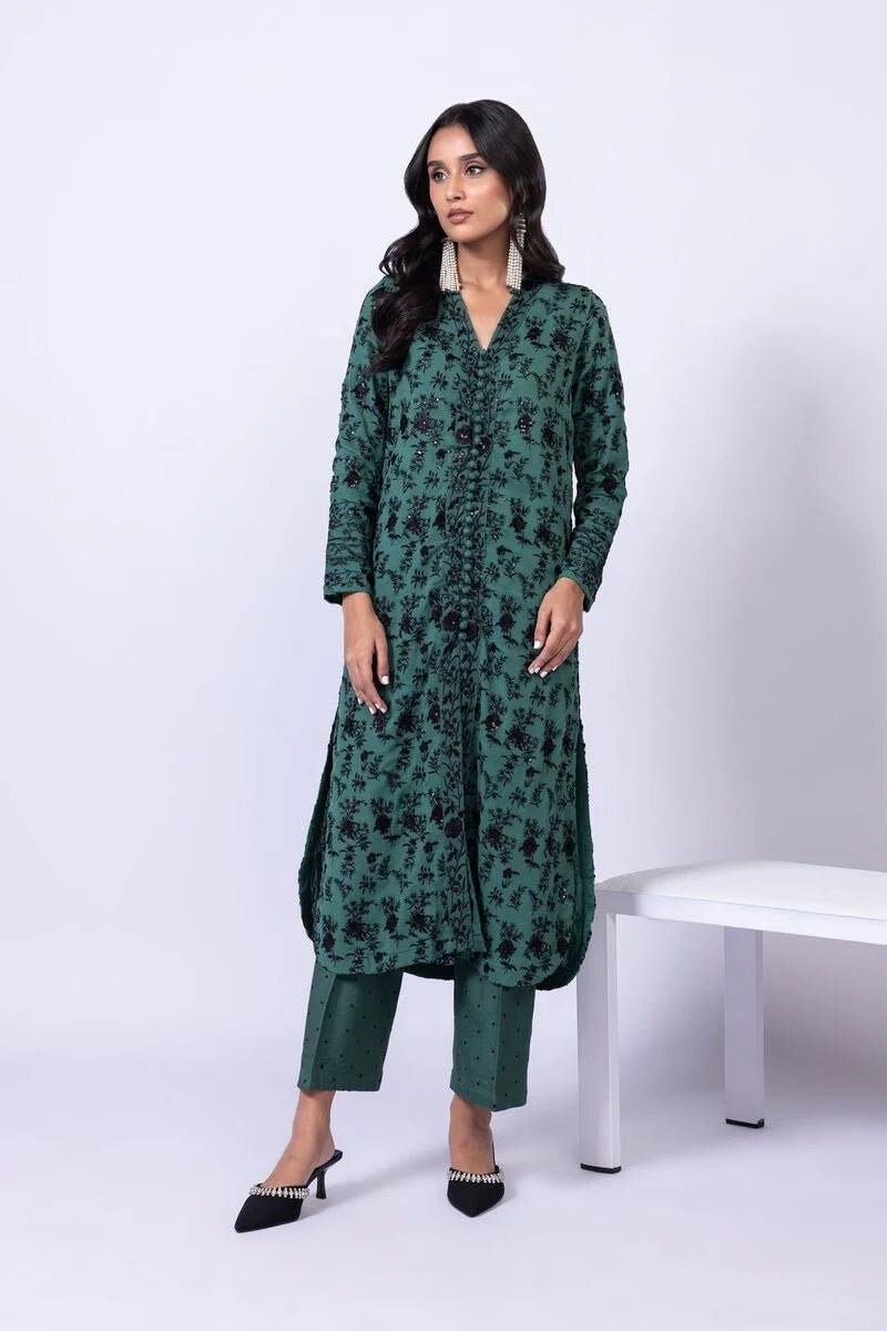 Model wearing Khaadi EST24635A green dress with black embroidered details and chiffon dupatta. Shop Pakistani clothes online in the UK now.