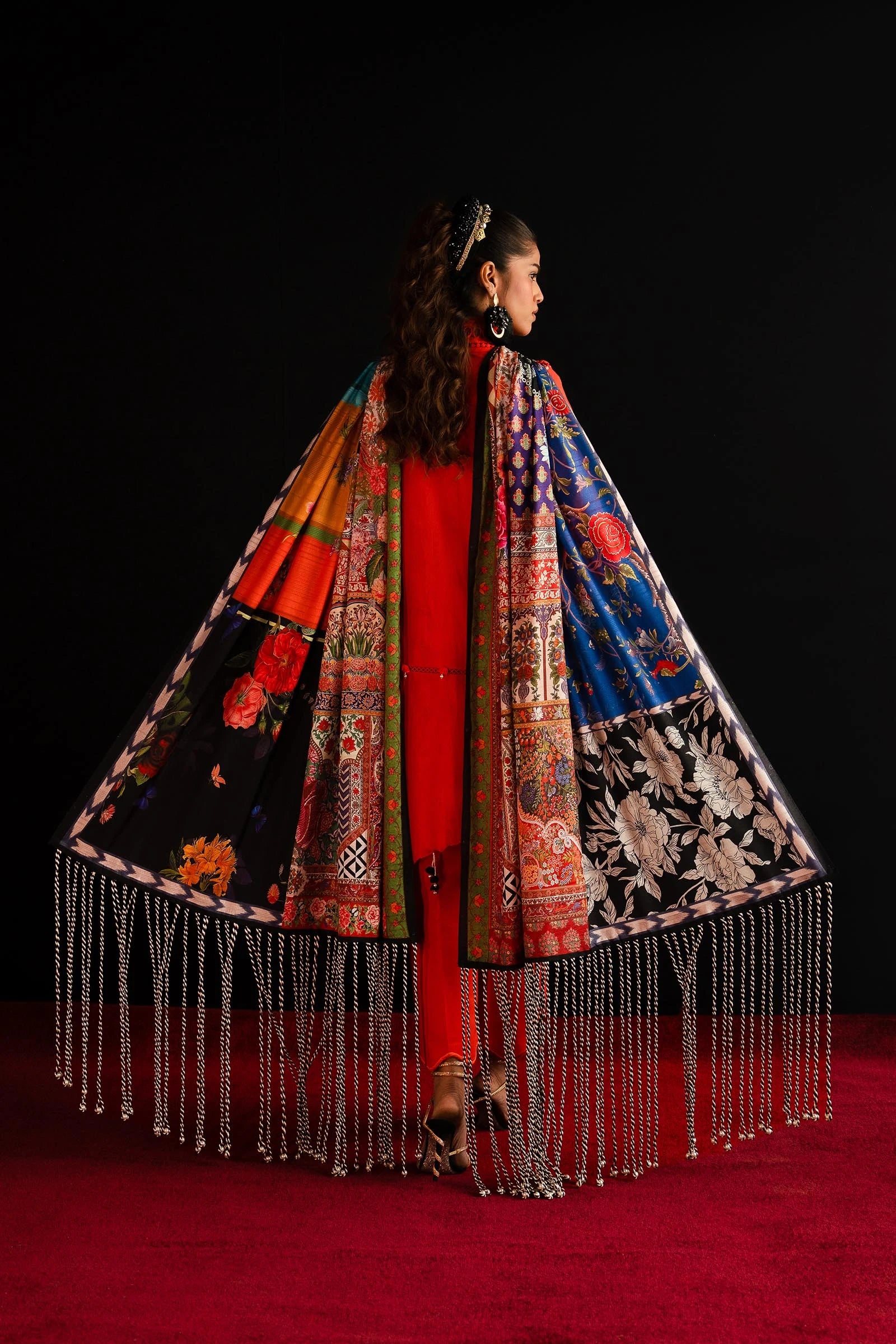 Model showcases Sana Safinaz's L241 - 001A - 3CL vibrant orange Pakistani dress, a UK luxury collection piece.