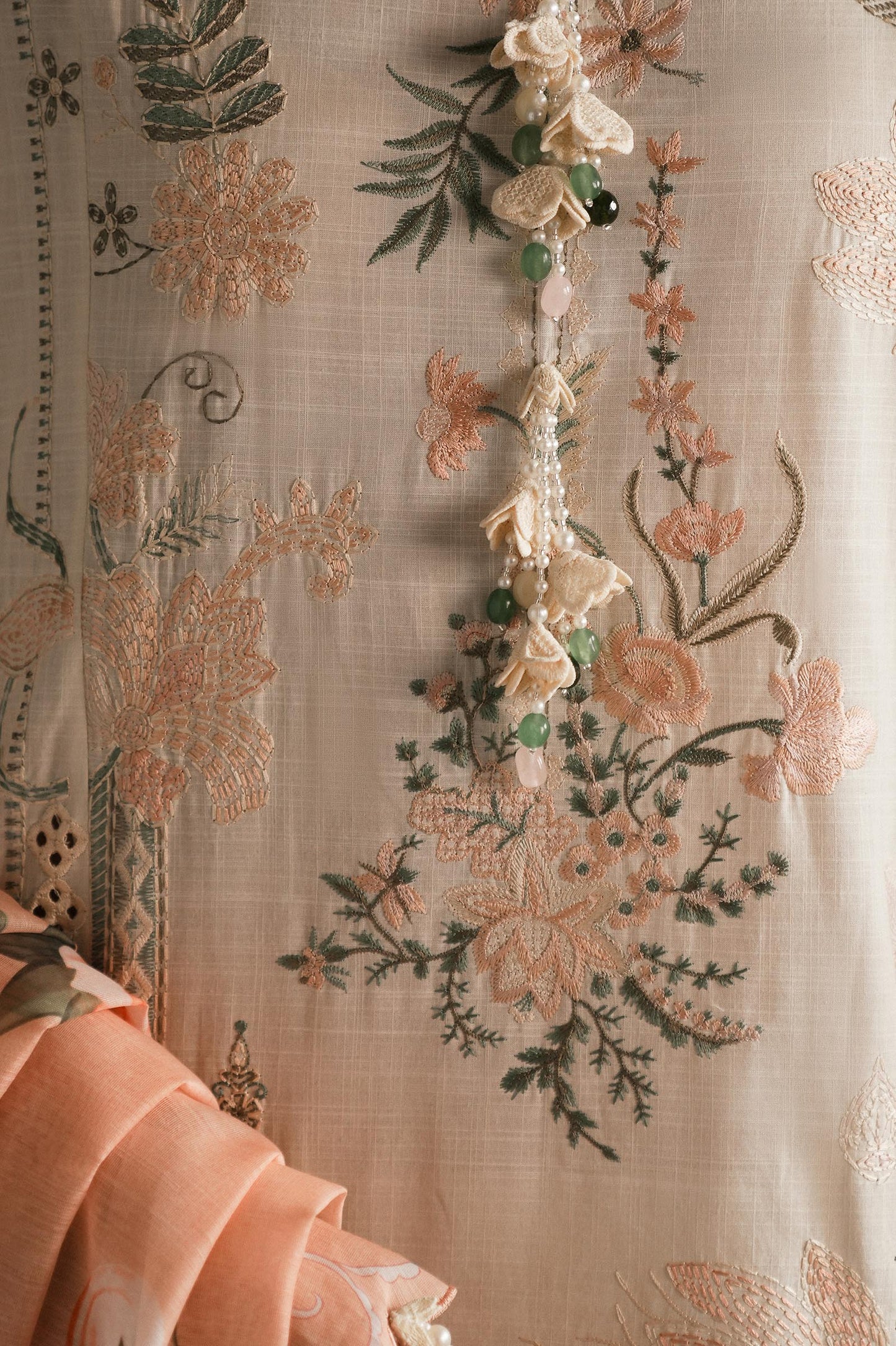 Model wearing ivory and peach embroidered outfit from Sana Safinaz, Luxury Lawn '25, perfect for Pakistani luxury pret online in UK.