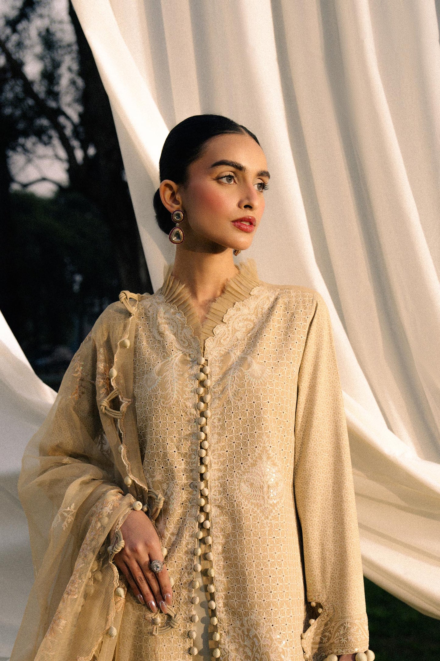 Model wearing beige embroidered outfit from Sana Safinaz, Luxury Lawn '25, perfect for Pakistani clothes online in UK and luxury pret.
