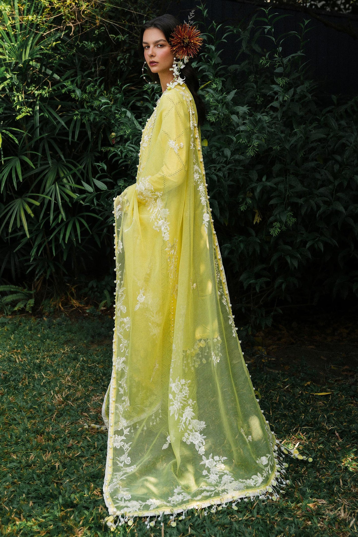 Model wearing lemon yellow embroidered outfit from Sana Safinaz, Luxury Lawn '25, ideal for Pakistani clothes online in UK and luxury pret.