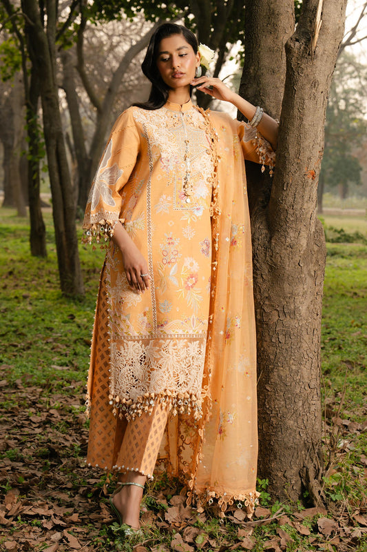 Model wearing mustard yellow embroidered dress with lace detailing from Sana Safinaz Luxury Lawn '25, Pakistani clothes online in UK.