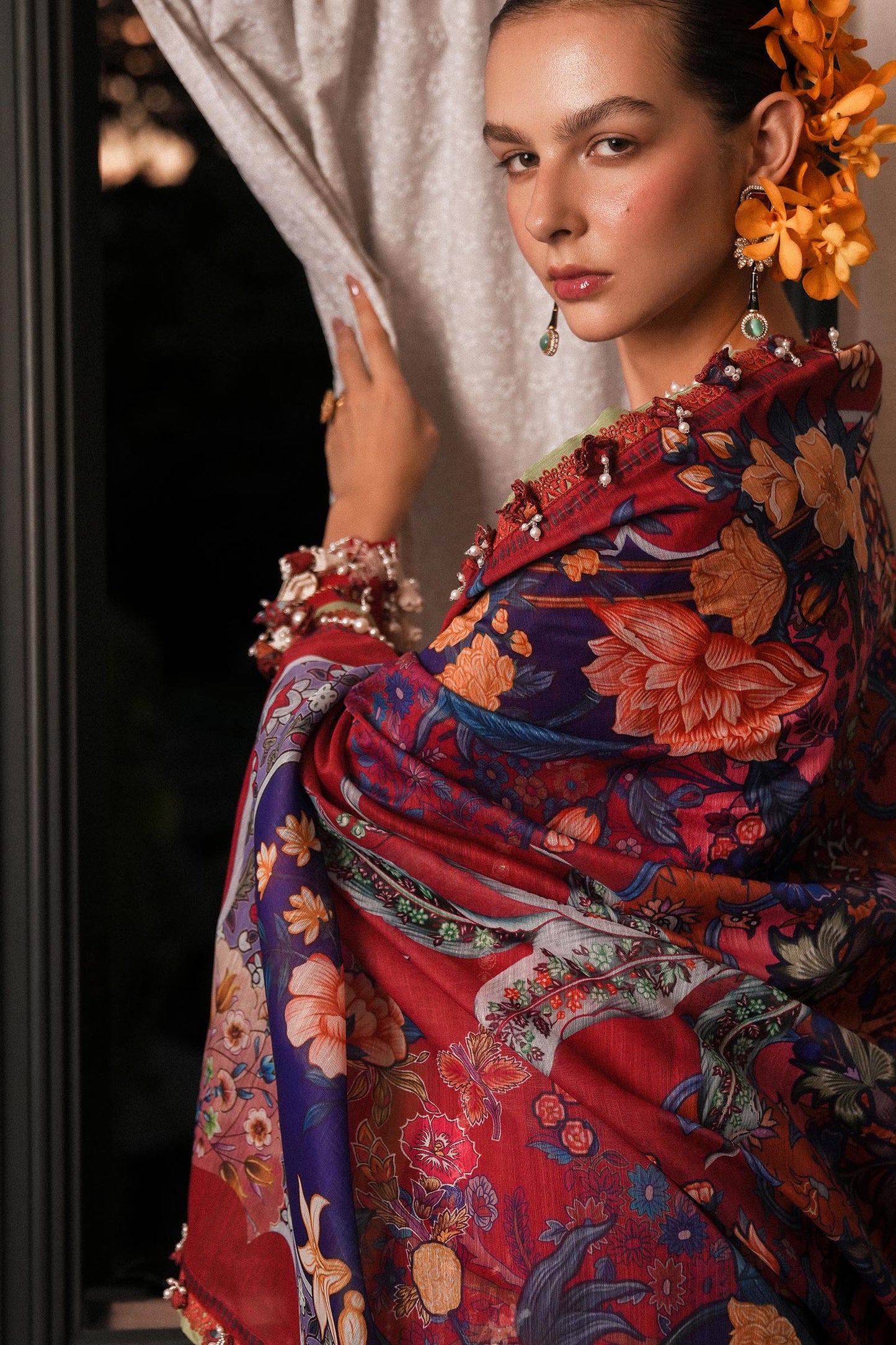 Model wearing deep red embroidered dress with multicolor dupatta from Sana Safinaz Luxury Lawn '25, Pakistani clothes online in UK.