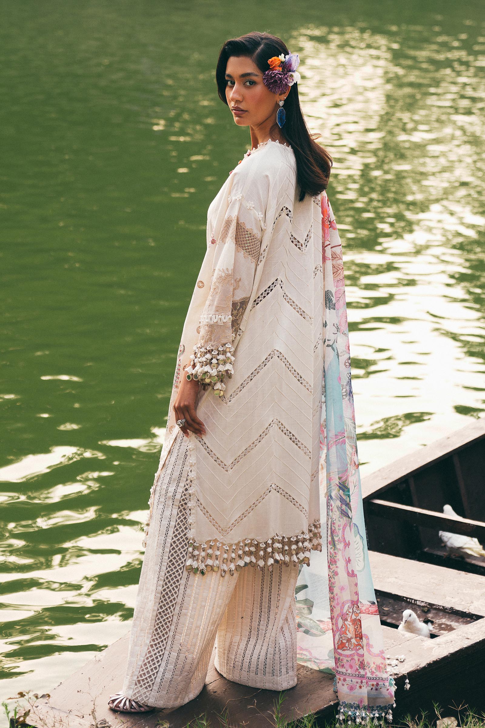 Model wearing ivory and pastel floral embroidered dress with printed dupatta from Sana Safinaz Luxury Lawn '25, Pakistani clothes online in UK.