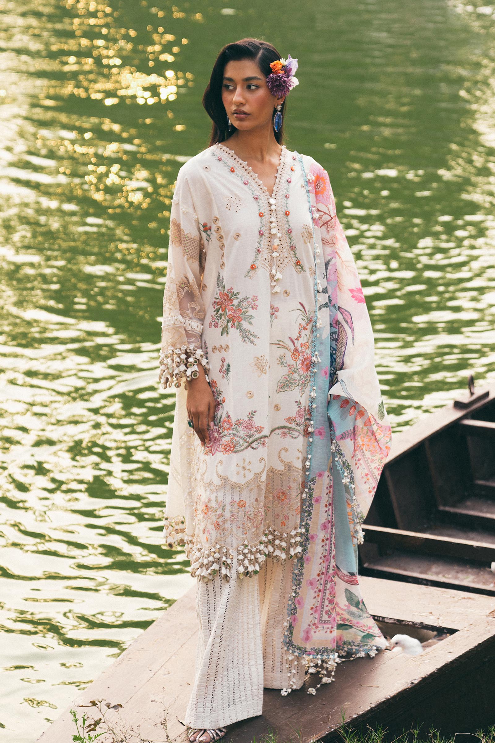 Model wearing ivory and pastel floral embroidered dress with printed dupatta from Sana Safinaz Luxury Lawn '25, Pakistani clothes online in UK.