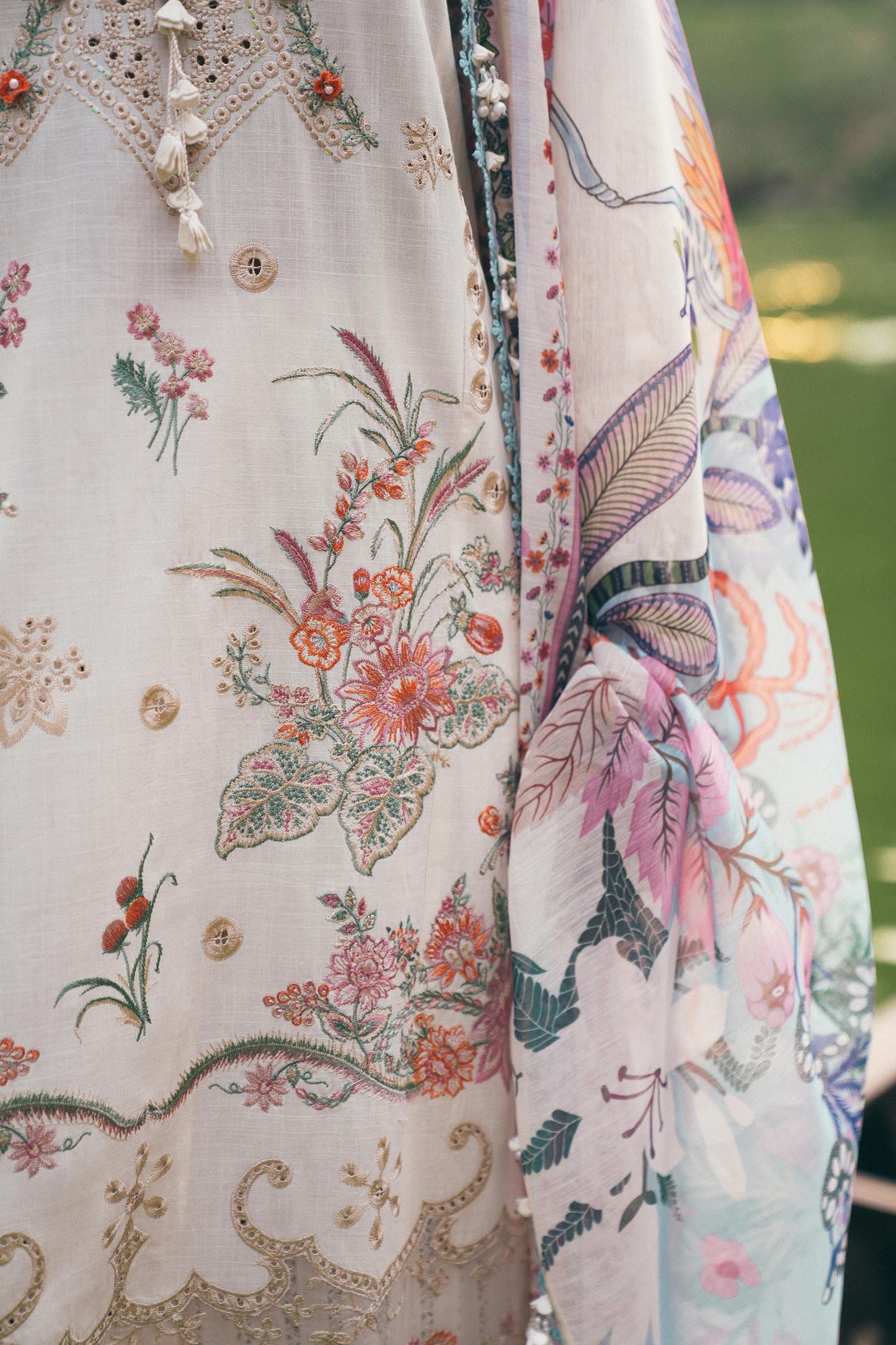 Model wearing ivory and pastel floral embroidered dress with printed dupatta from Sana Safinaz Luxury Lawn '25, Pakistani clothes online in UK.