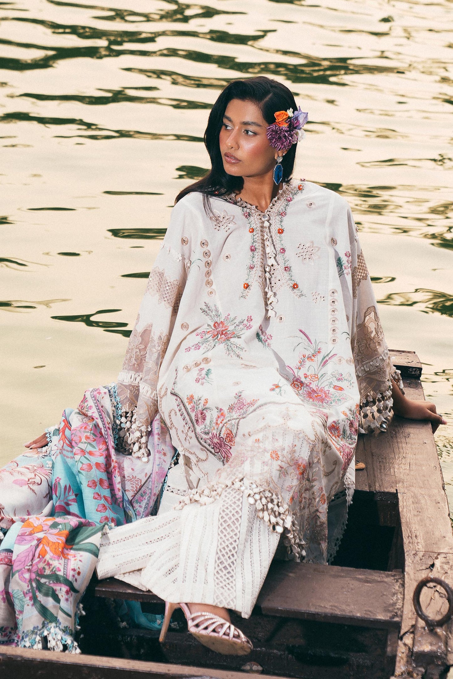 Model wearing ivory and pastel floral embroidered dress with printed dupatta from Sana Safinaz Luxury Lawn '25, Pakistani clothes online in UK.