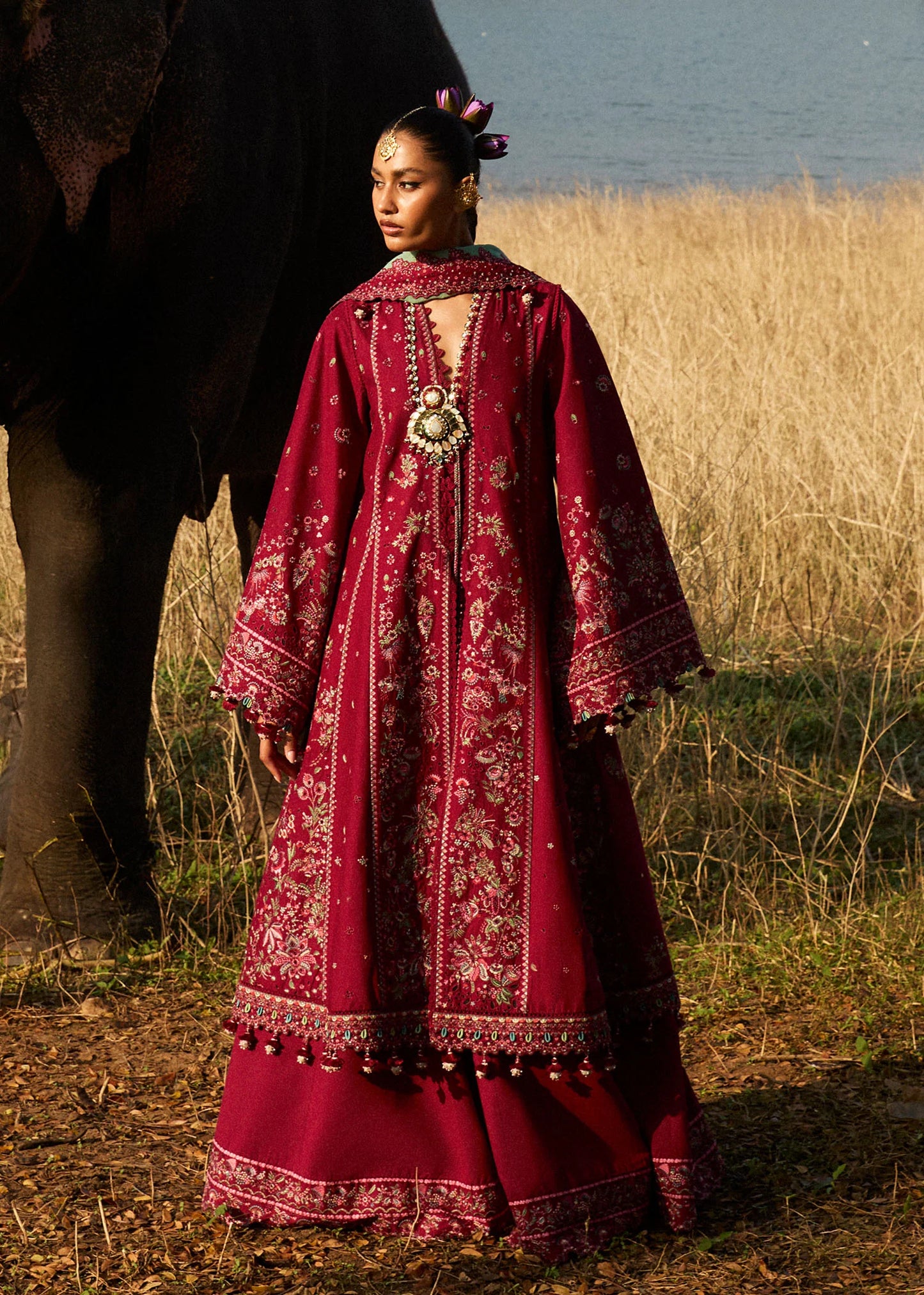 Model wearing Hussain Rehar Luxury Lawn '25 Mahogany in maroon with intricate embroidery. Shop Pakistani luxury pret online in the UK.