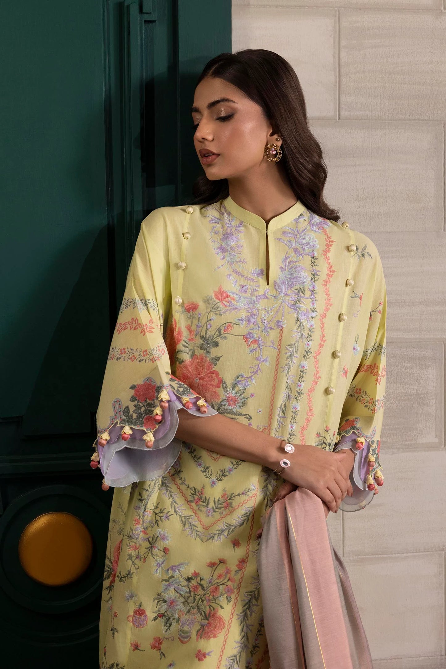 Model wearing lemon yellow floral printed dress with striped pastel dupatta from Sana Safinaz Muzlin Spring '25, Pakistani Luxury pret UK.