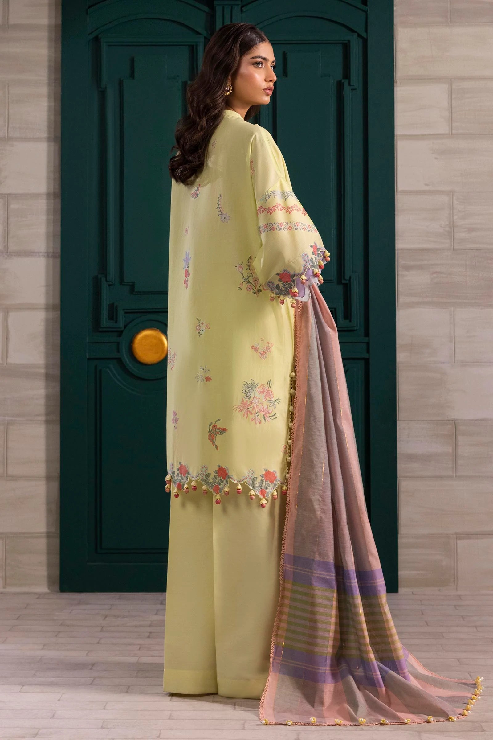 Model wearing lemon yellow floral printed dress with striped pastel dupatta from Sana Safinaz Muzlin Spring '25, Pakistani Luxury pret UK.