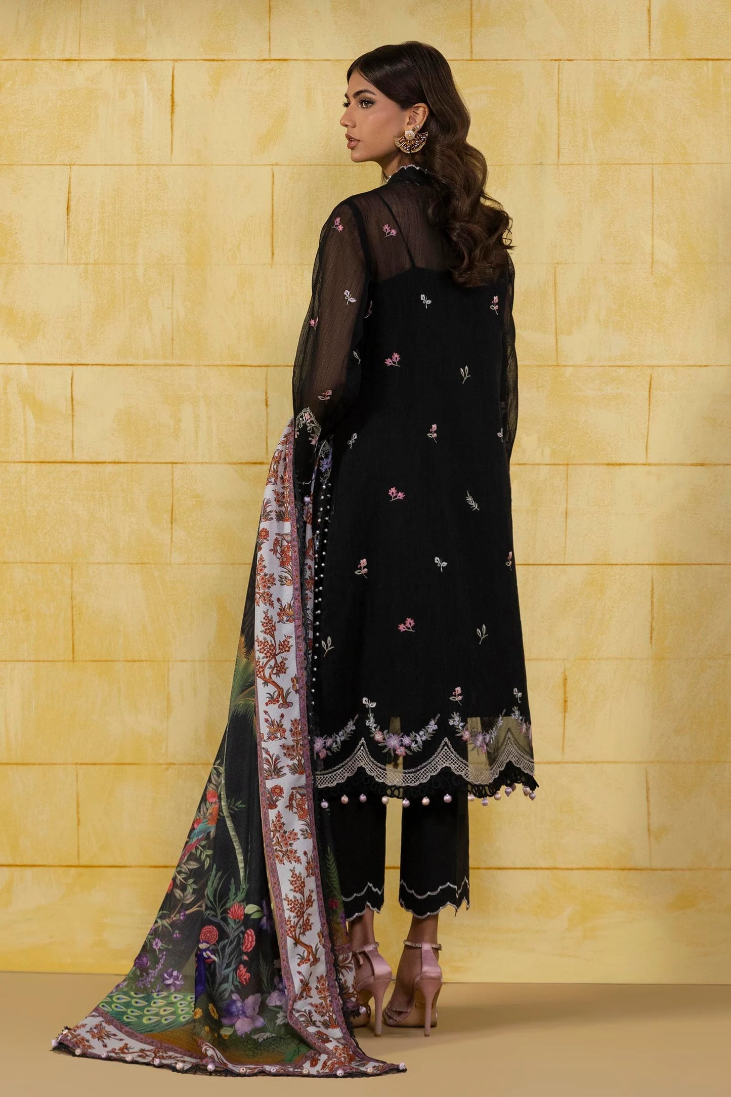 Model wearing black floral embroidered dress with multicolour printed dupatta from Sana Safinaz Muzlin Spring '25, Pakistani Luxury pret UK.