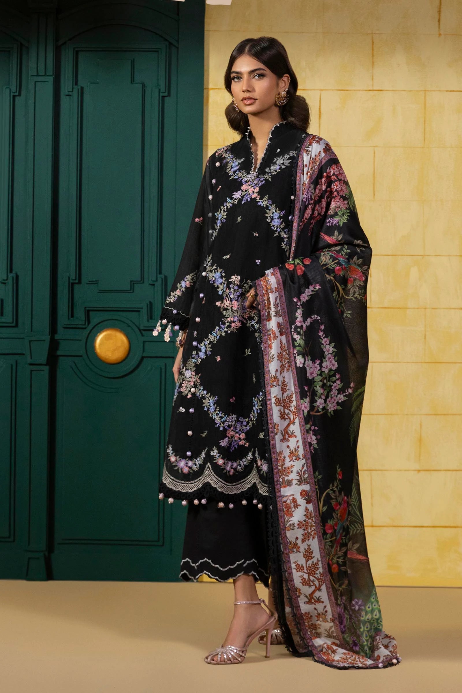 Model wearing black floral embroidered dress with multicolour printed dupatta from Sana Safinaz Muzlin Spring '25, Pakistani Luxury pret UK.