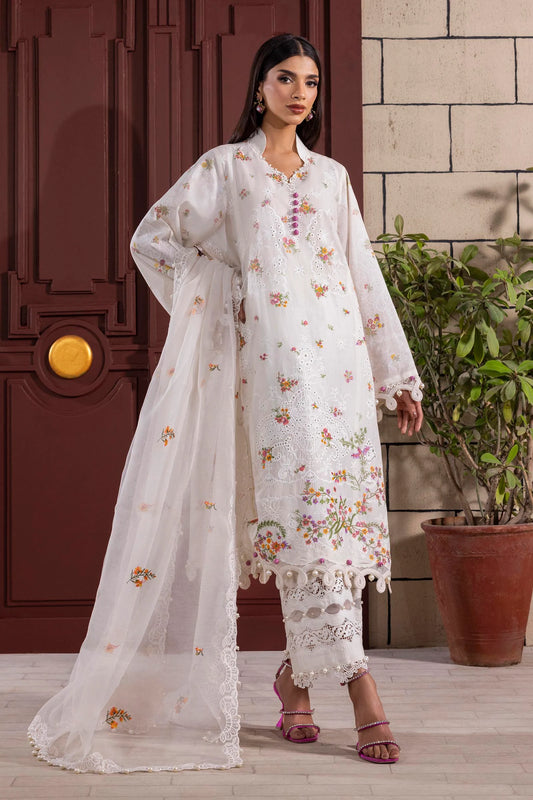 Model wearing white embroidered dress with multicolor floral accents and lace detailing from Sana Safinaz Muzlin Spring '25, Pakistani clothes online UK.