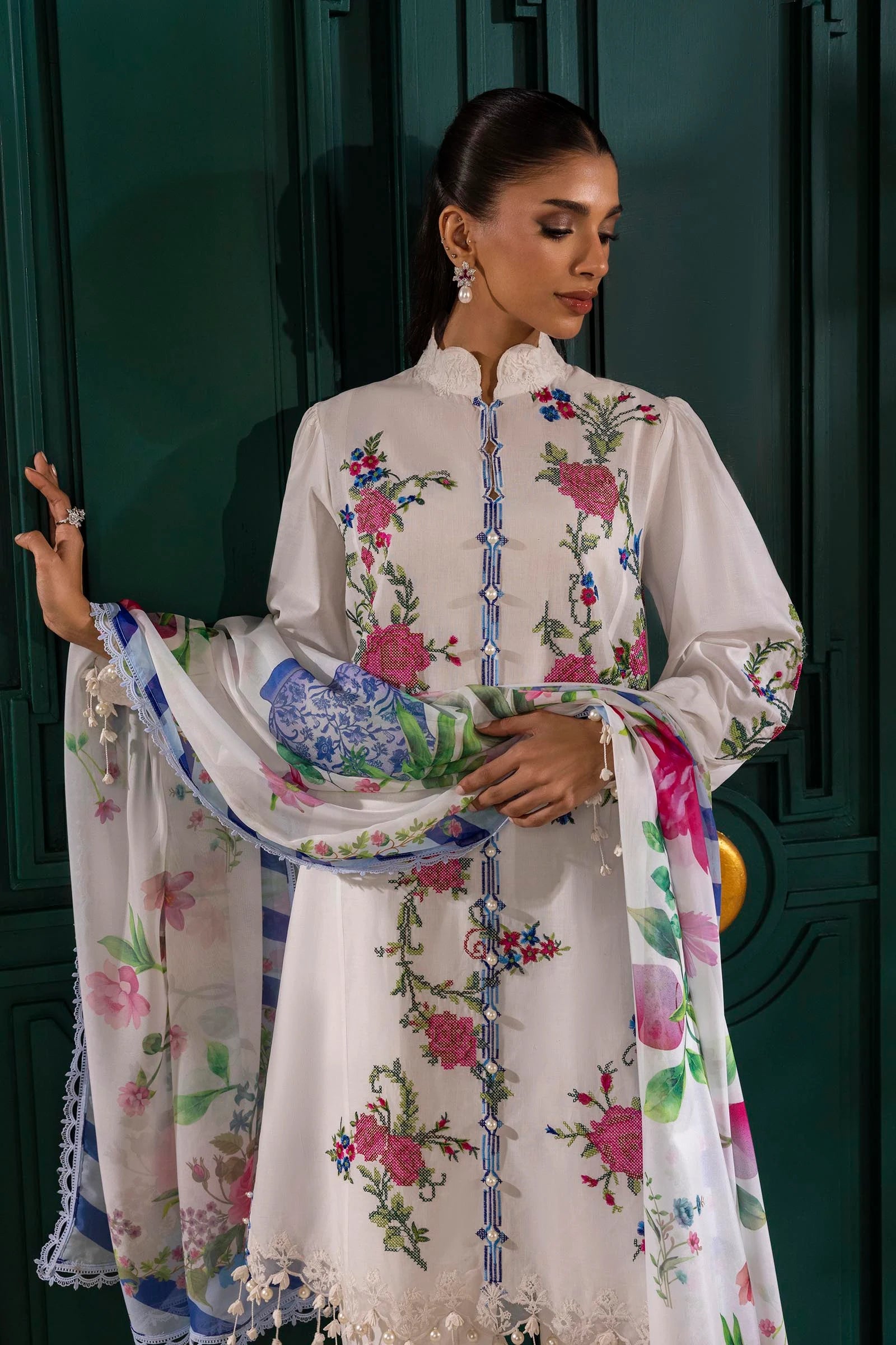 Model wearing white Sana Safinaz M251-013A-3CL outfit with vibrant pink floral embroidery and blue striped dupatta, Pakistani Luxury pret online UK.