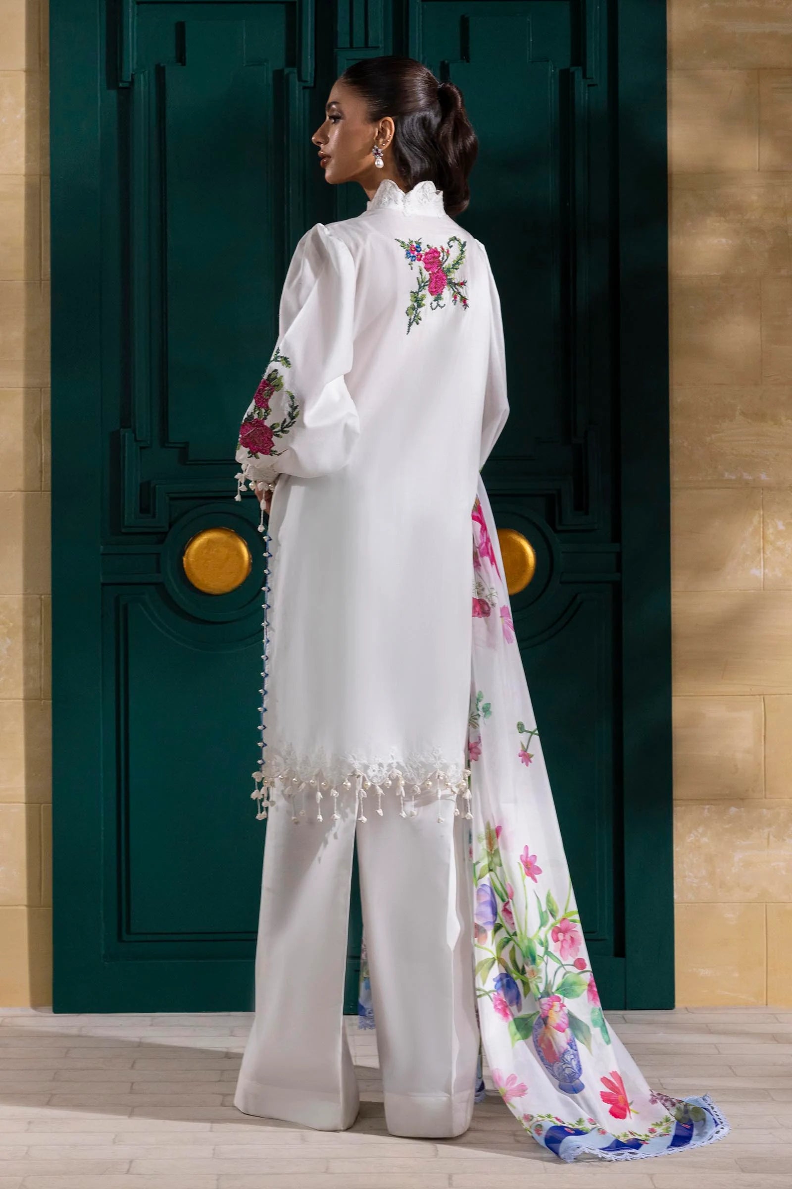 Model wearing white Sana Safinaz M251-013A-3CL outfit with vibrant pink floral embroidery and blue striped dupatta, Pakistani Luxury pret online UK.