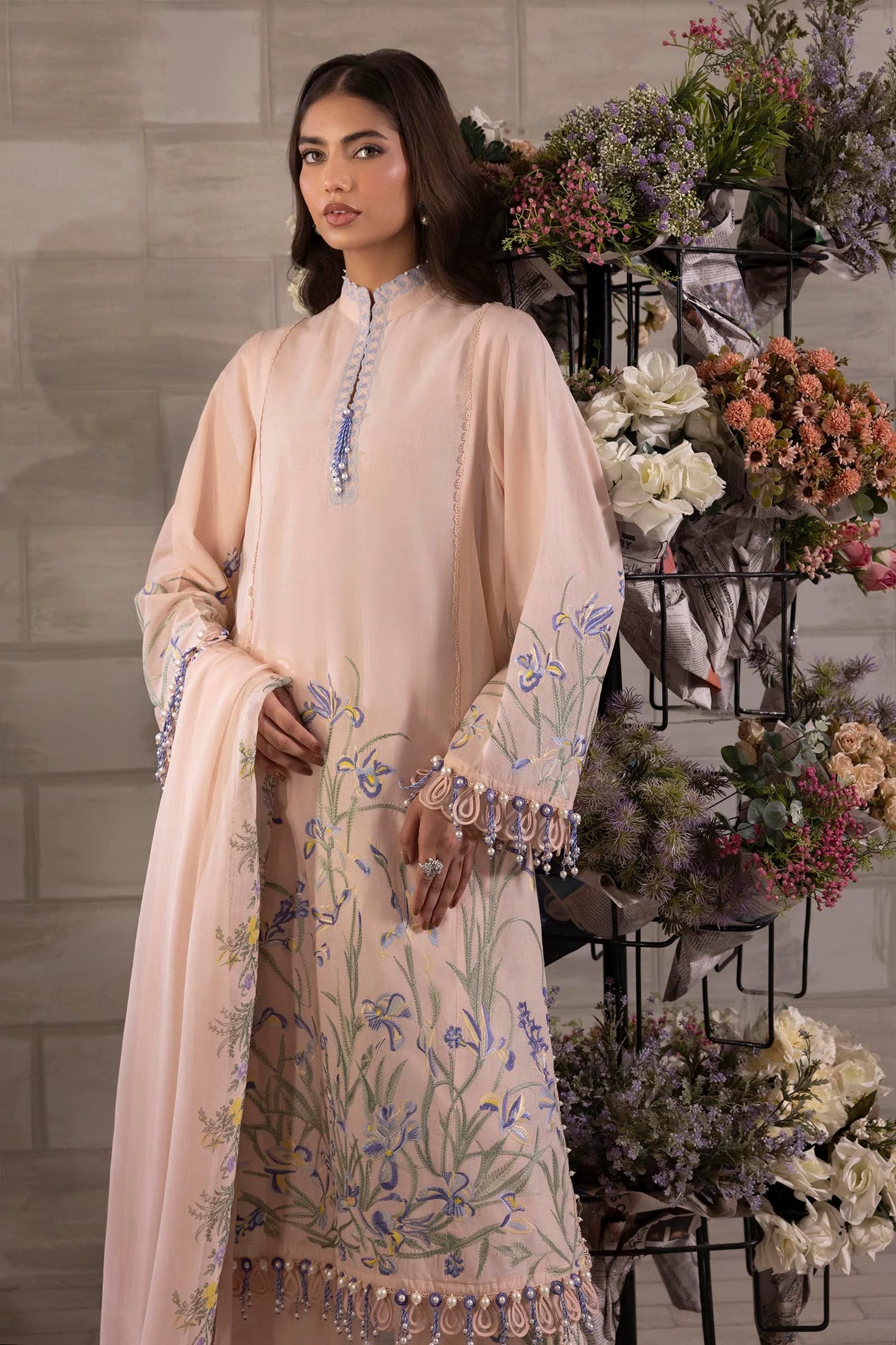 Model wearing peach Sana Safinaz M251-017B-3CJ outfit with blue floral embroidery and matching dupatta, Pakistani Luxury pret in UK.