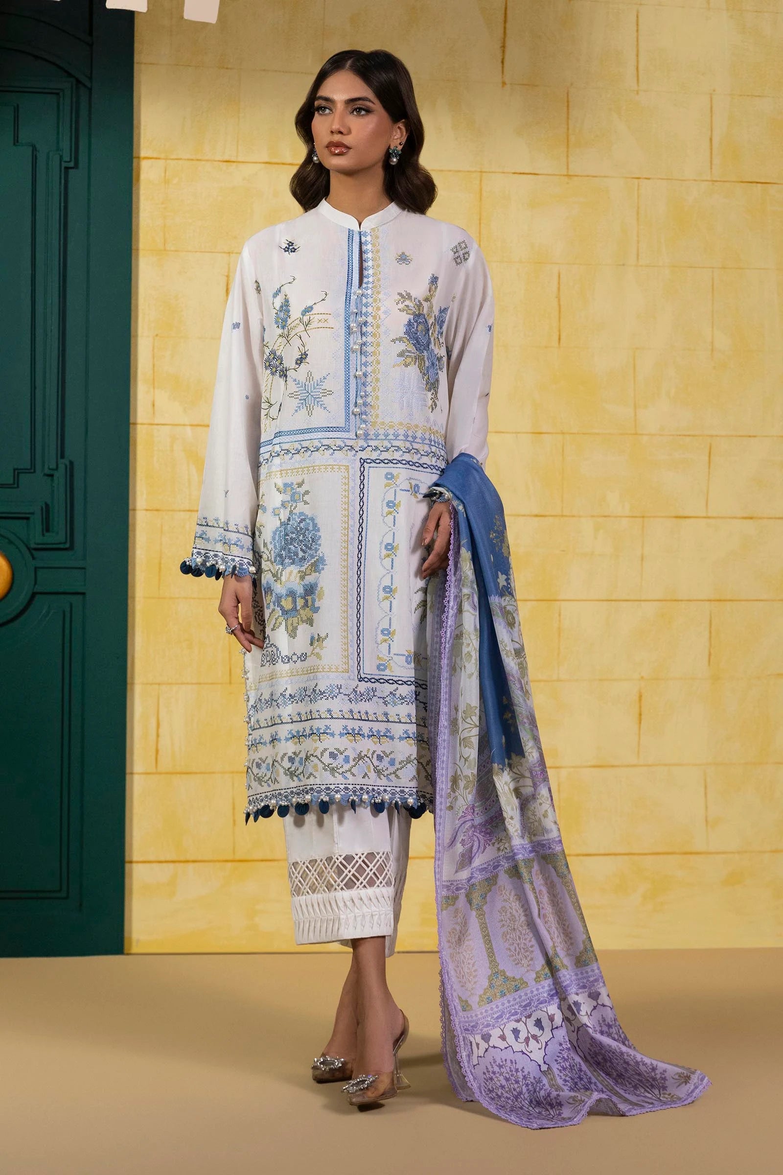 Model wearing white Sana Safinaz M251-018A-3CT outfit with blue embroidered motifs and purple printed dupatta, Pakistani Luxury pret in UK.