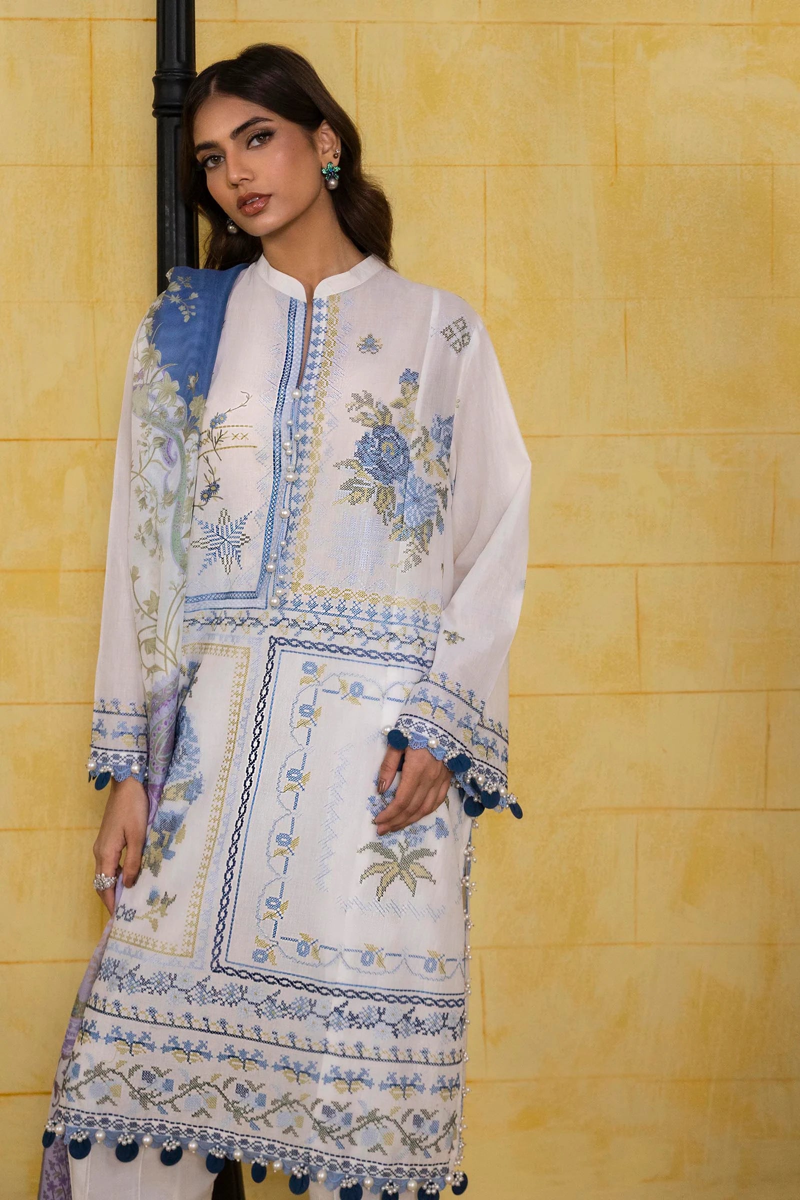 Model wearing white Sana Safinaz M251-018A-3CT outfit with blue embroidered motifs and purple printed dupatta, Pakistani Luxury pret in UK.