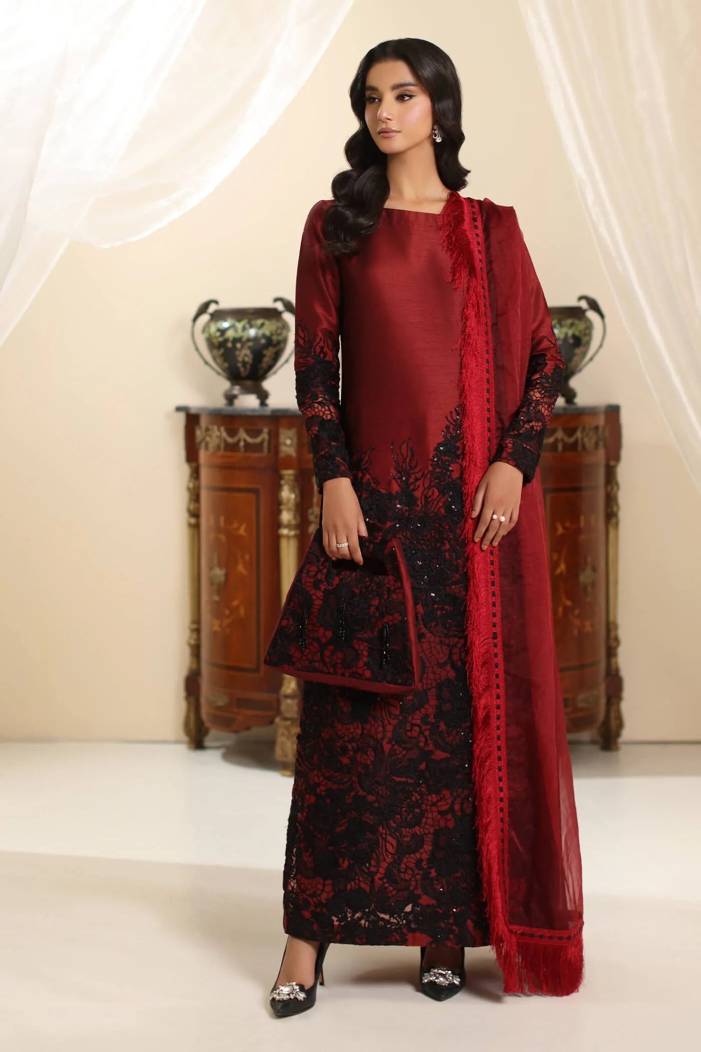 Model wearing Musferah Saad Dark Rose dress in rich red and black from the Amor a La Vida collection, ideal for Pakistani wedding clothes online in the UK.