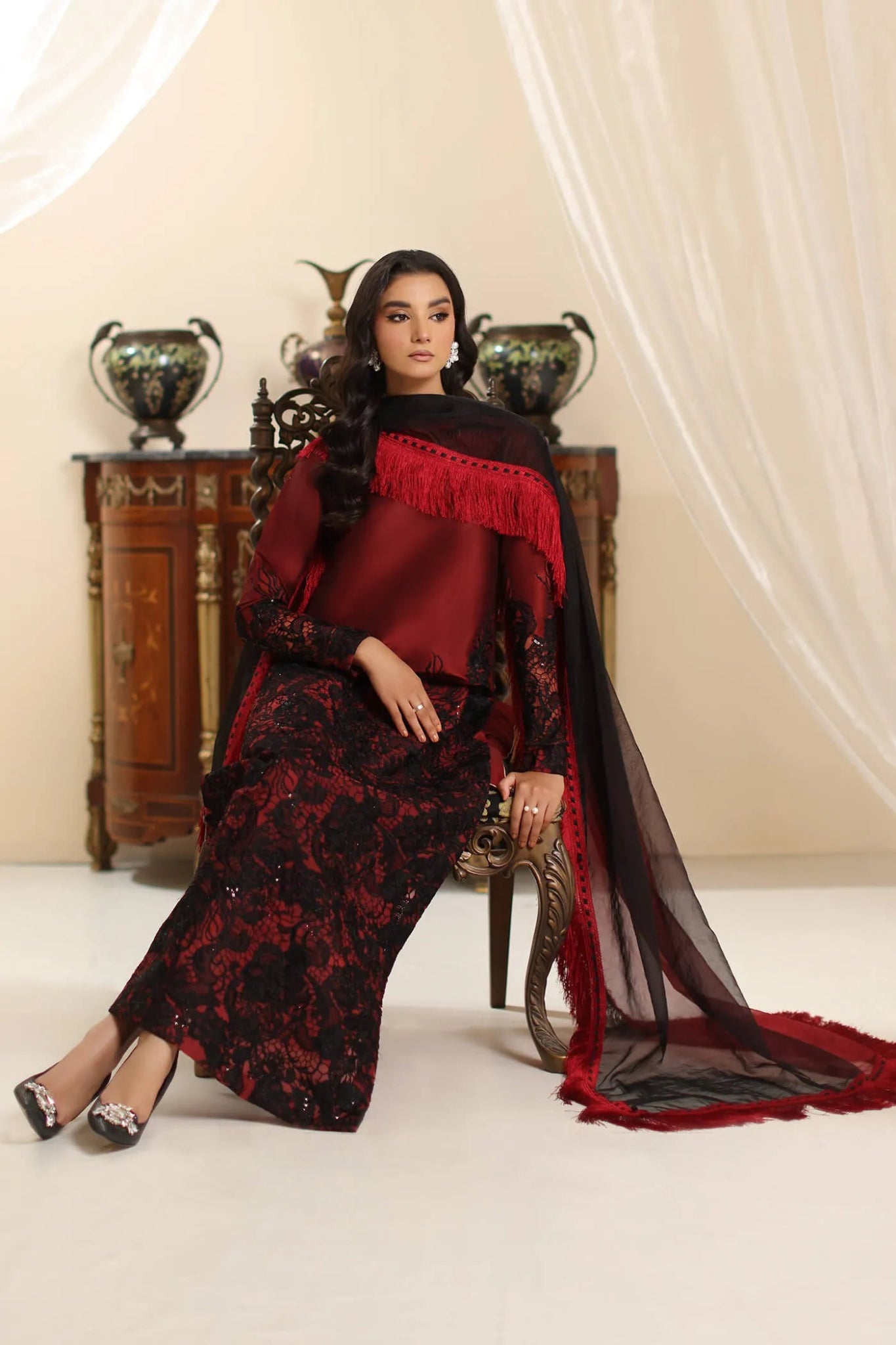 Model wearing Musferah Saad Dark Rose dress in rich red and black from the Amor a La Vida collection, ideal for Pakistani wedding clothes online in the UK.