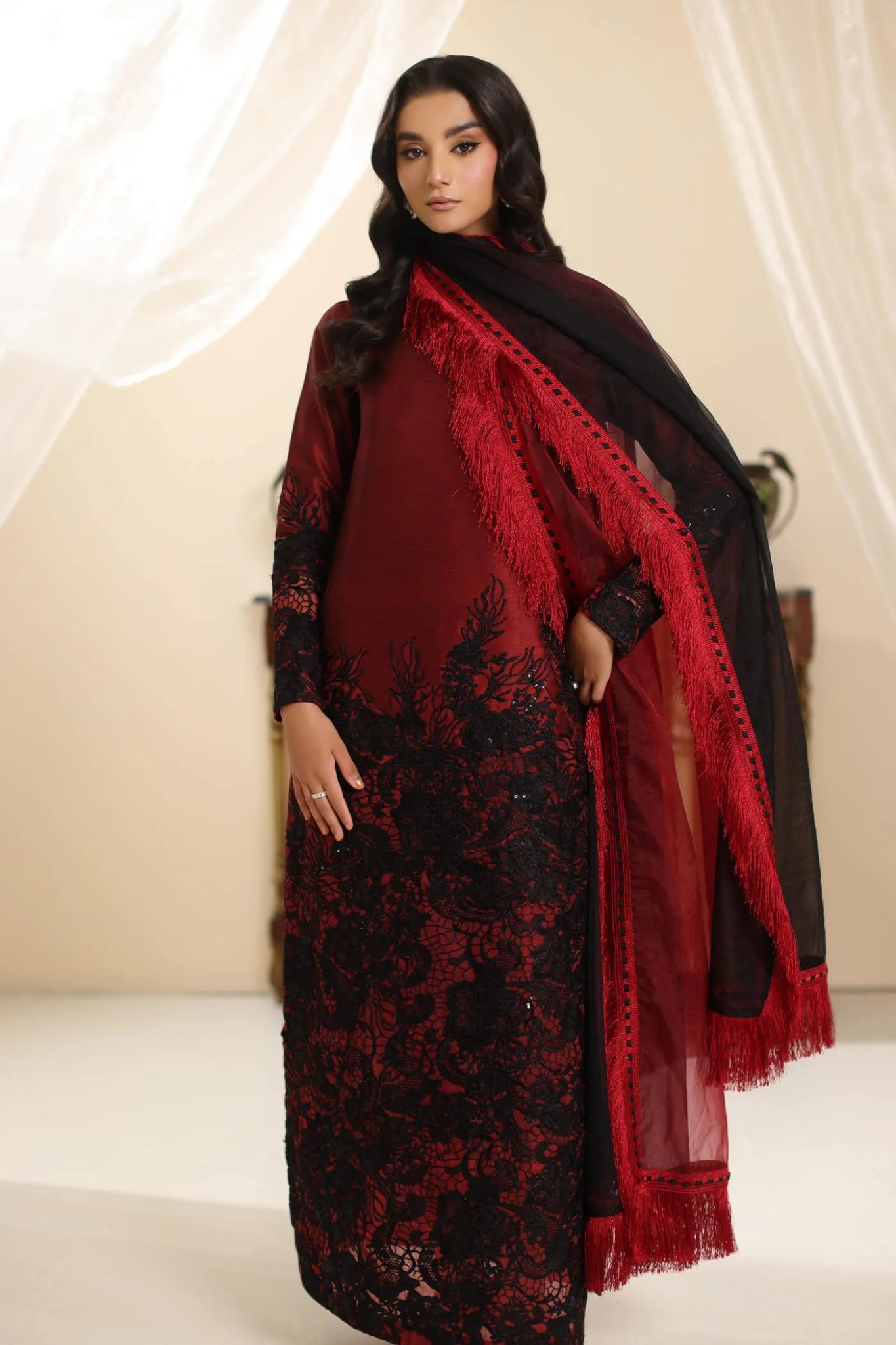 Model wearing Musferah Saad Dark Rose dress in rich red and black from the Amor a La Vida collection, ideal for Pakistani wedding clothes online in the UK.