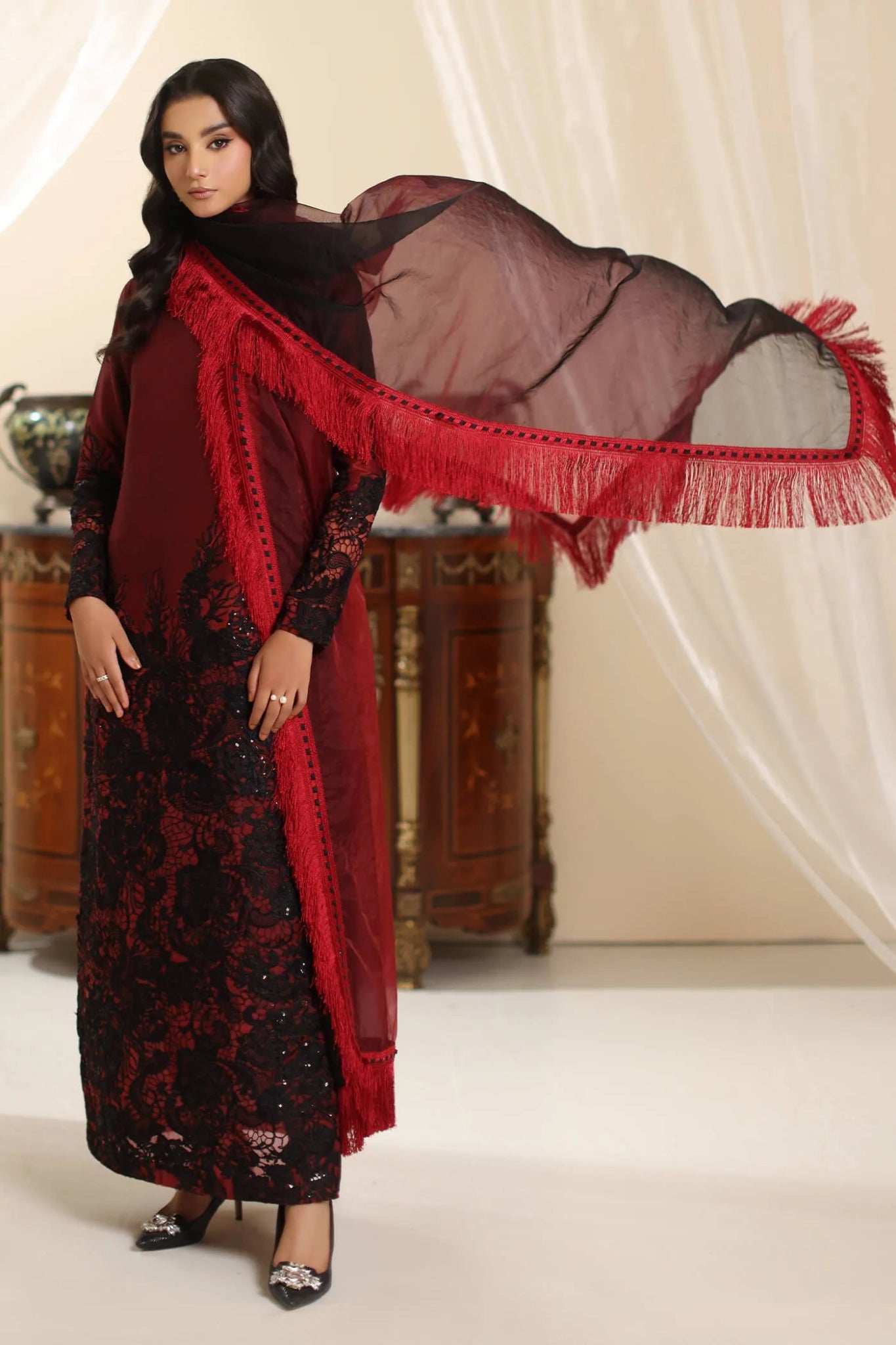 Model wearing Musferah Saad Dark Rose dress in rich red and black from the Amor a La Vida collection, ideal for Pakistani wedding clothes online in the UK.