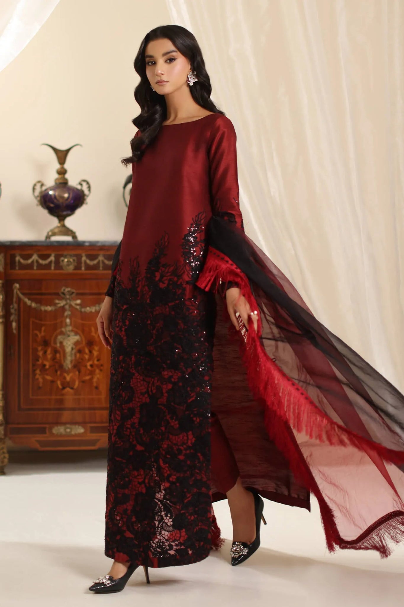 Model wearing Musferah Saad Dark Rose dress in rich red and black from the Amor a La Vida collection, ideal for Pakistani wedding clothes online in the UK.