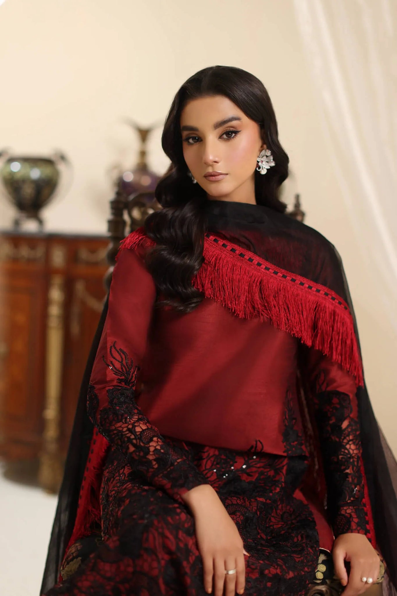 Model wearing Musferah Saad Dark Rose dress in rich red and black from the Amor a La Vida collection, ideal for Pakistani wedding clothes online in the UK.