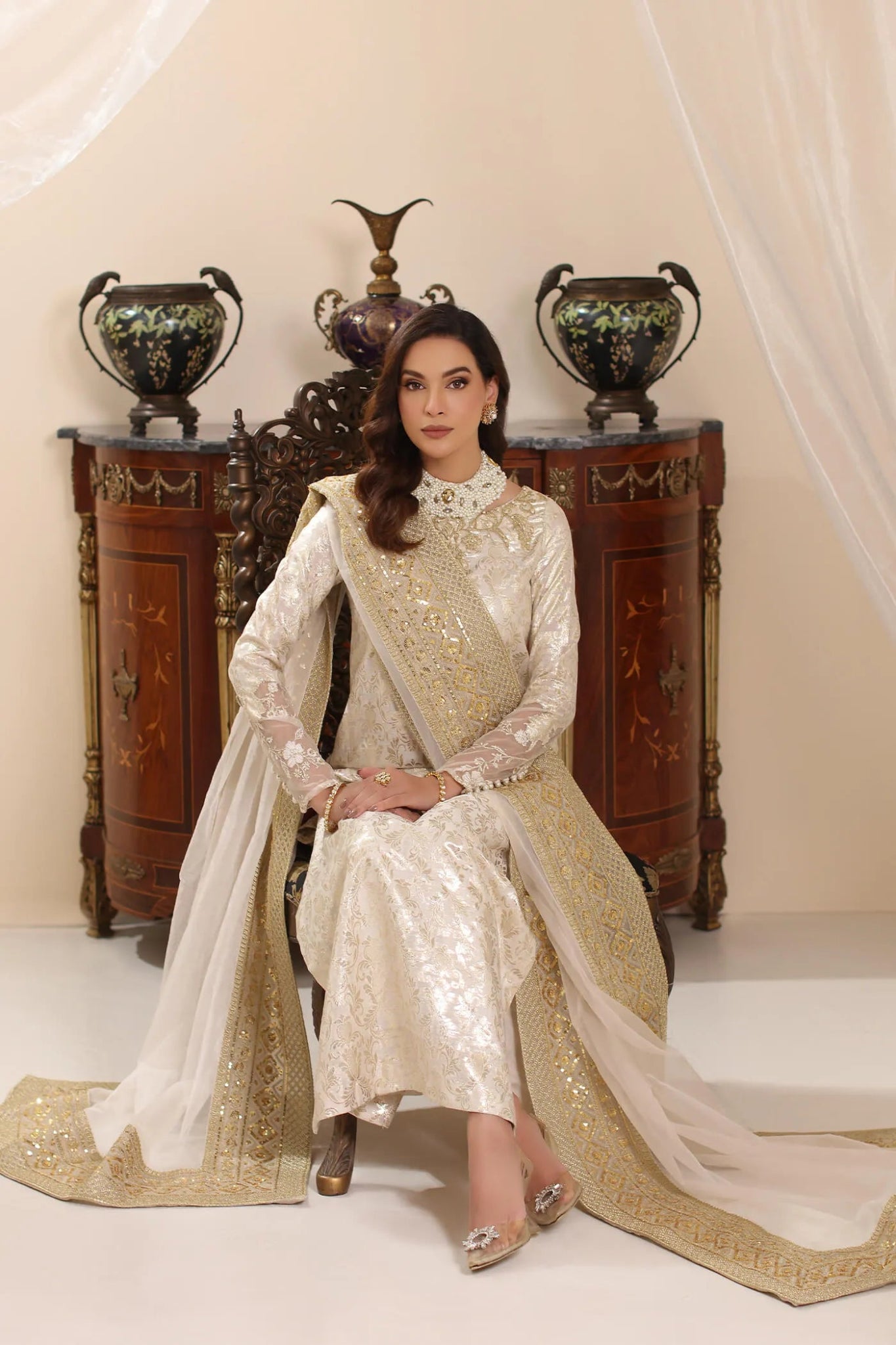 Model wearing Musferah Saad Ivory Stardust dress from the Amor a La Vida collection in elegant ivory with gold embellishments, ideal for Pakistani wedding clothes online in the UK.