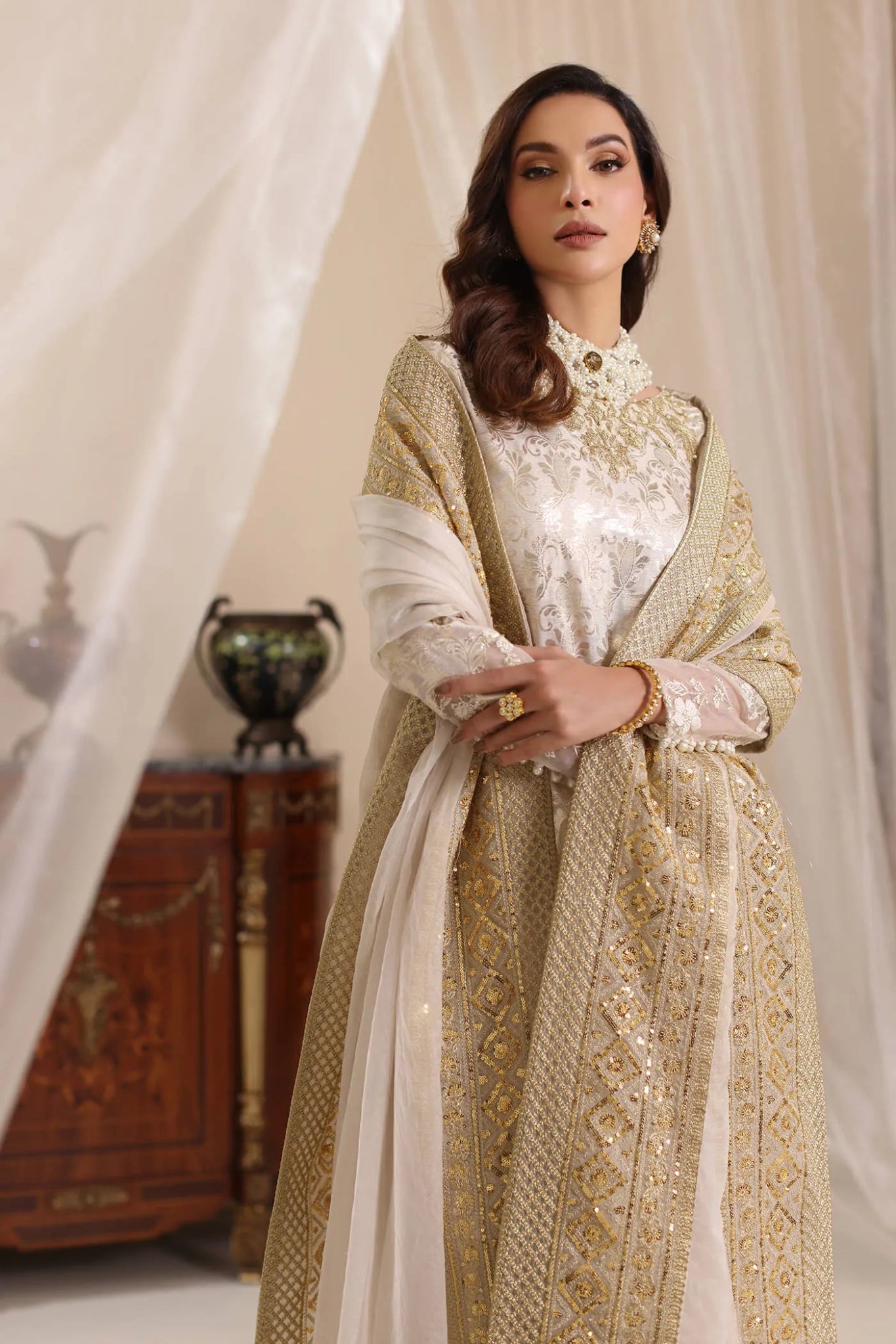 Model wearing Musferah Saad Ivory Stardust dress from the Amor a La Vida collection in elegant ivory with gold embellishments, ideal for Pakistani wedding clothes online in the UK.