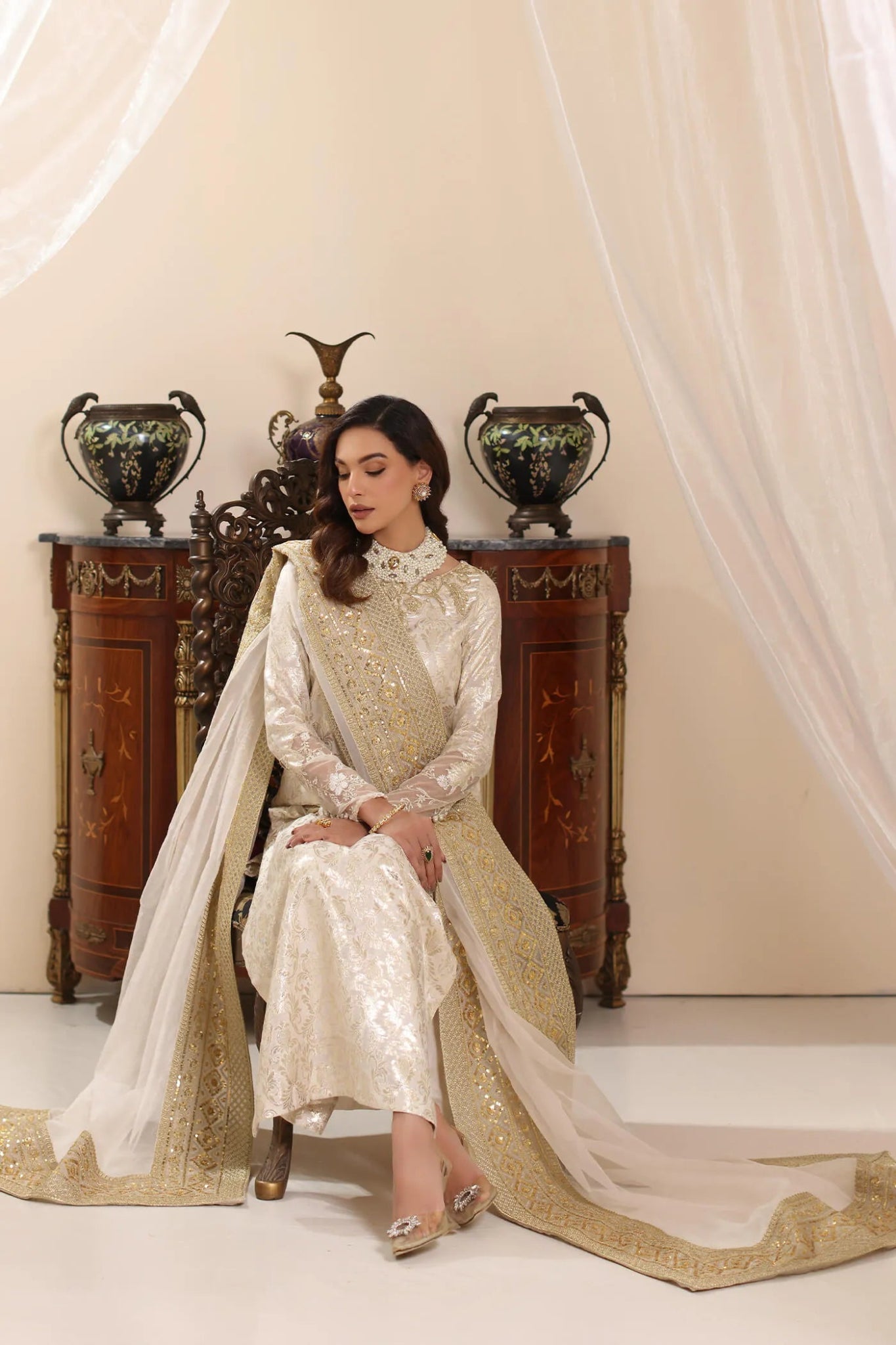 Model wearing Musferah Saad Ivory Stardust dress from the Amor a La Vida collection in elegant ivory with gold embellishments, ideal for Pakistani wedding clothes online in the UK.