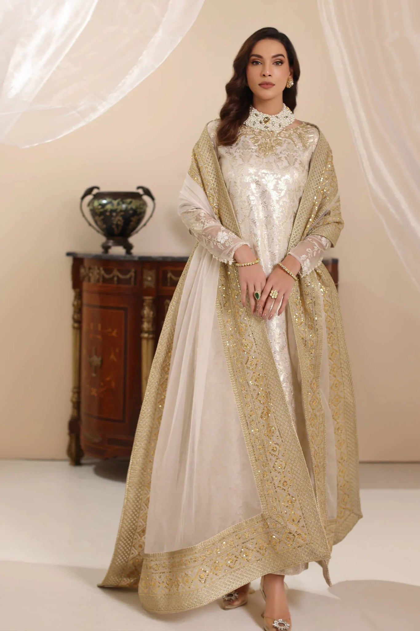 Model wearing Musferah Saad Ivory Stardust dress from the Amor a La Vida collection in elegant ivory with gold embellishments, ideal for Pakistani wedding clothes online in the UK.