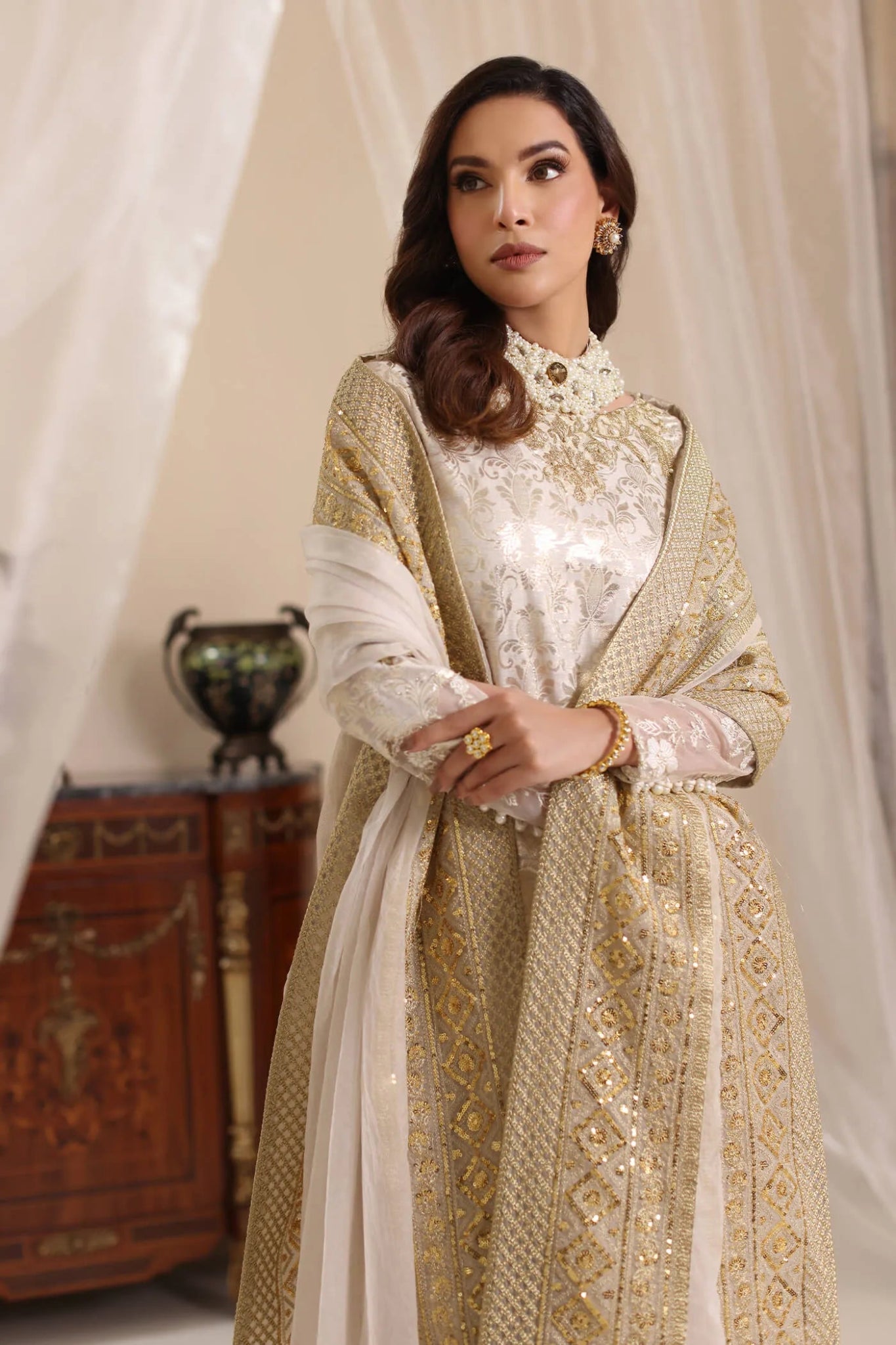 Model wearing Musferah Saad Ivory Stardust dress from the Amor a La Vida collection in elegant ivory with gold embellishments, ideal for Pakistani wedding clothes online in the UK.