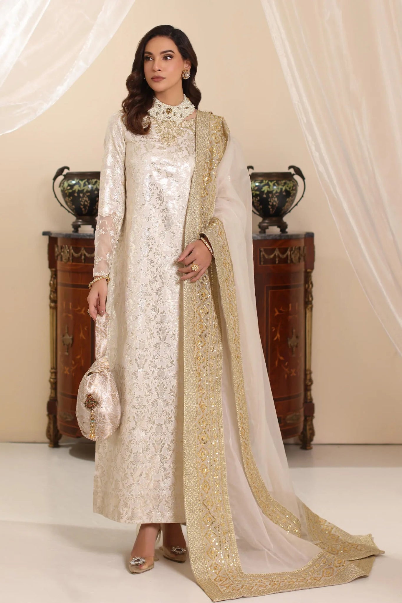 Model wearing Musferah Saad Ivory Stardust dress from the Amor a La Vida collection in elegant ivory with gold embellishments, ideal for Pakistani wedding clothes online in the UK.